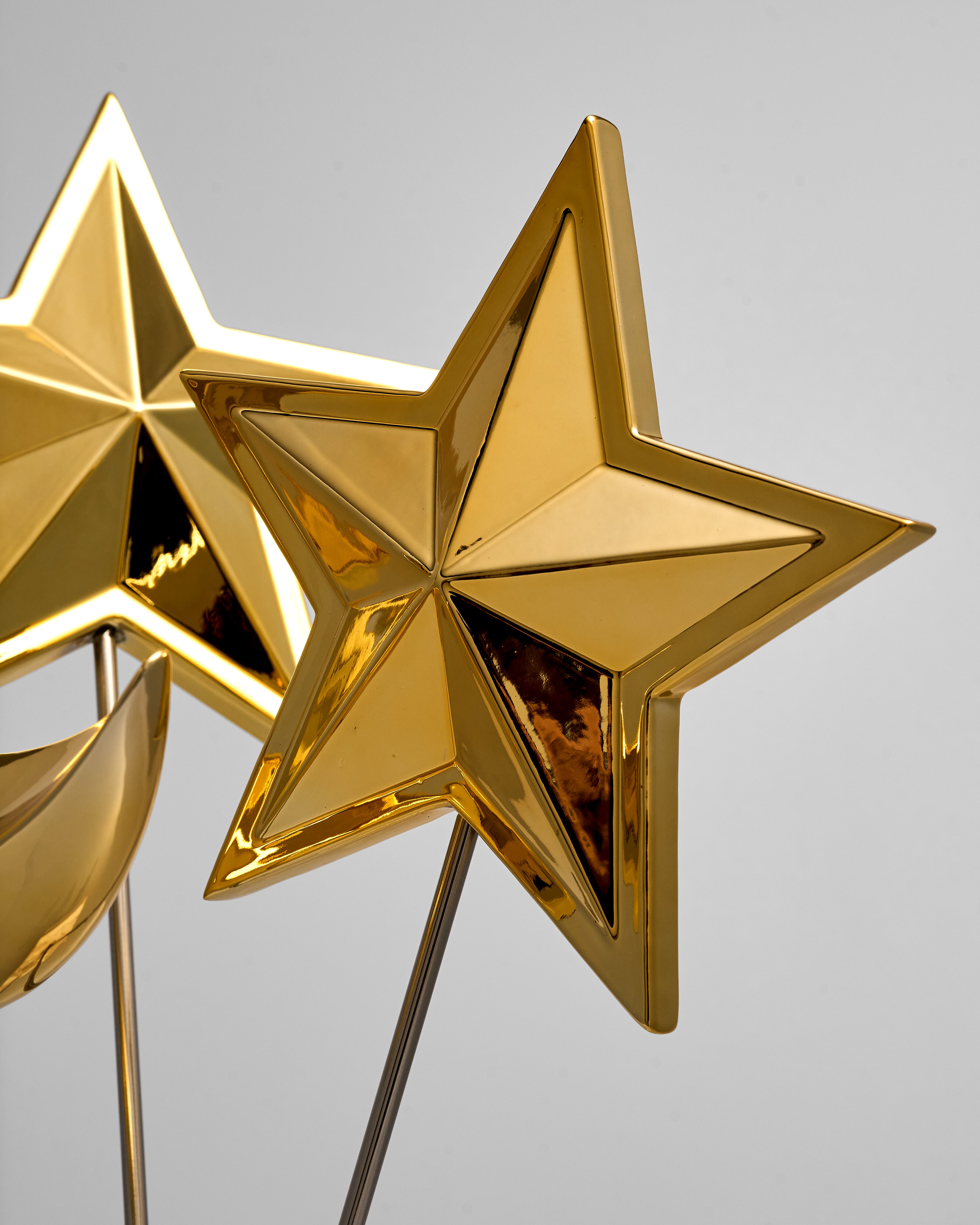 Gold star-shaped decorative items on a gray background