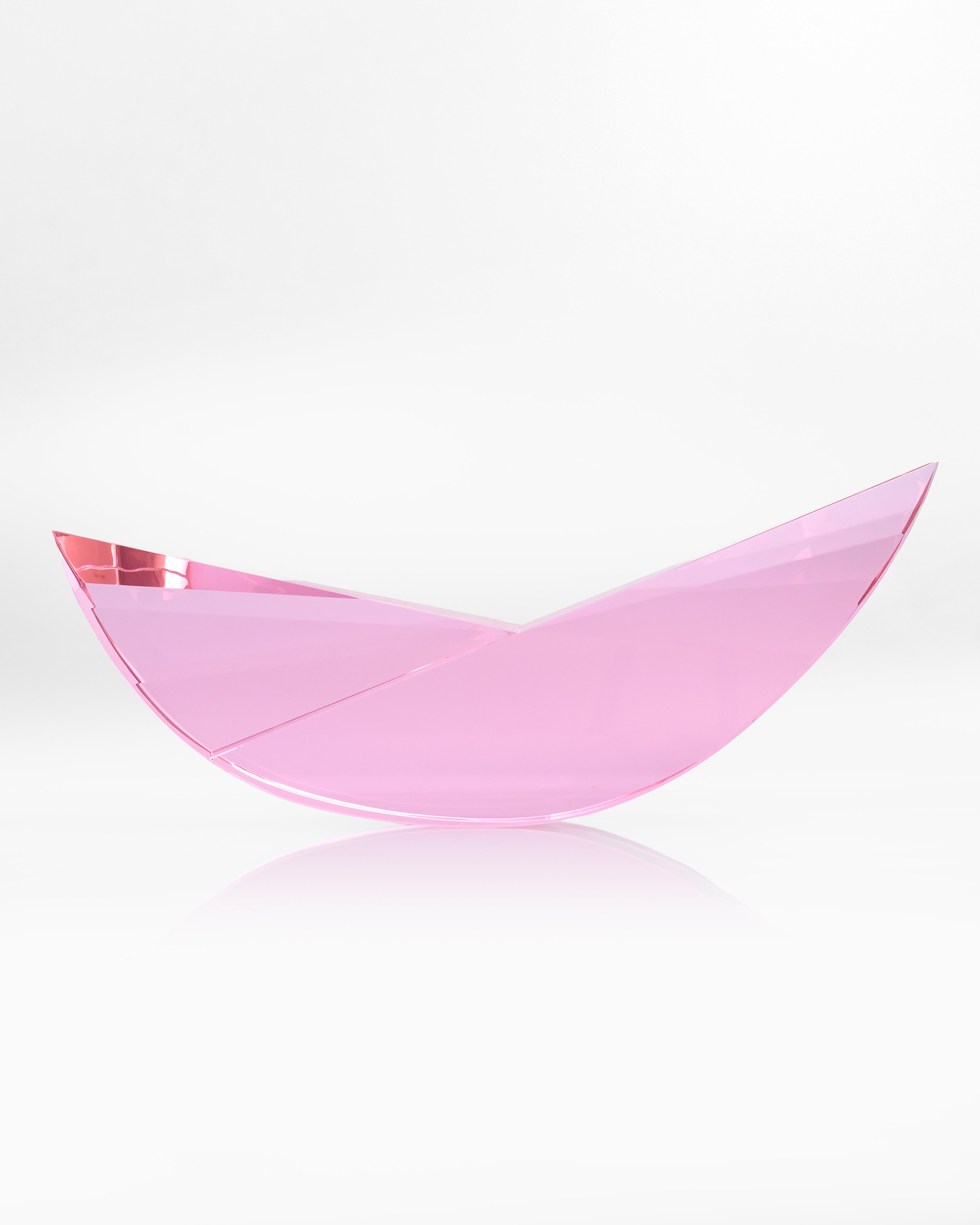 Pink crescent-shaped object on a white background