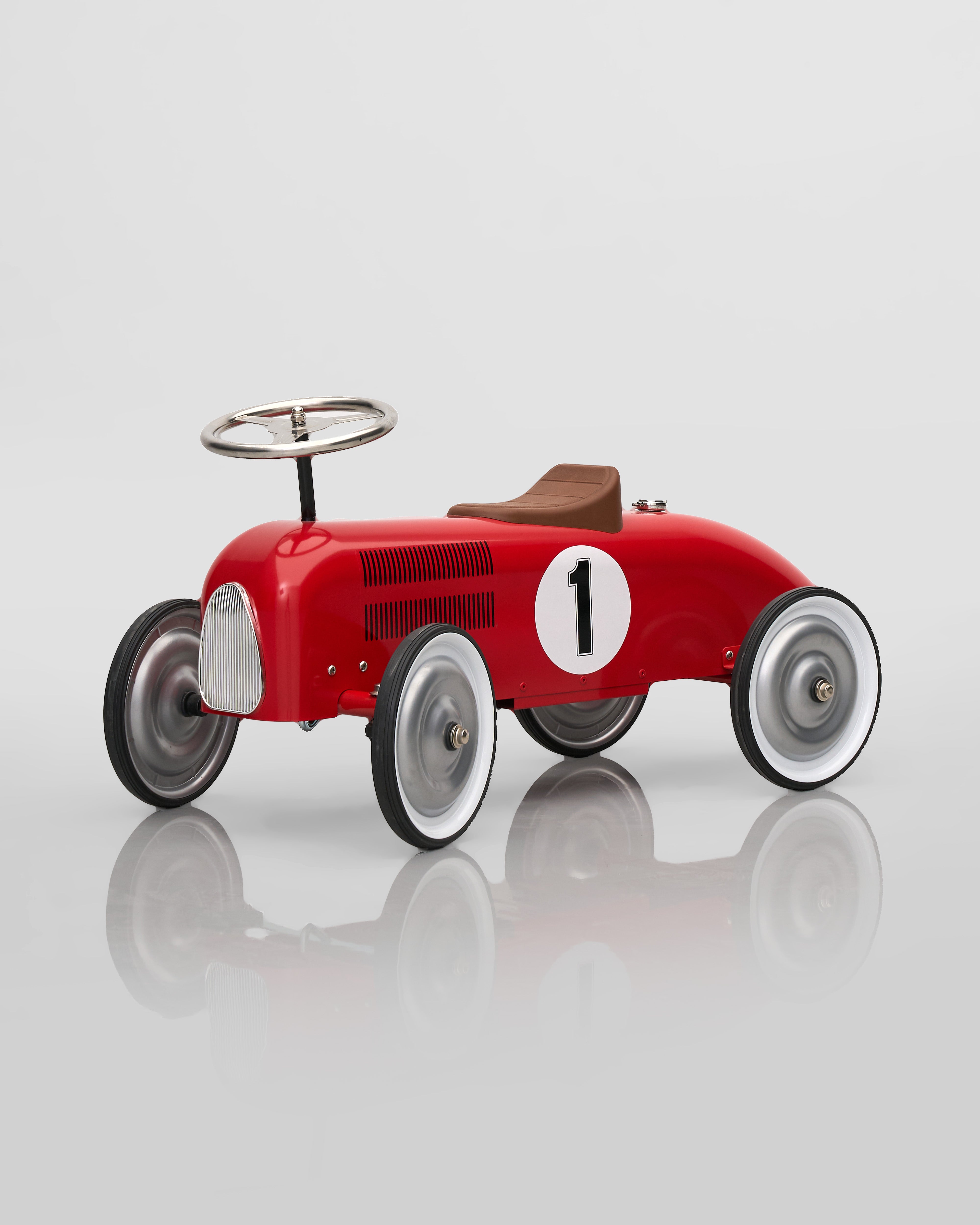Red vintage-style toy car with number 1 on a reflective surface