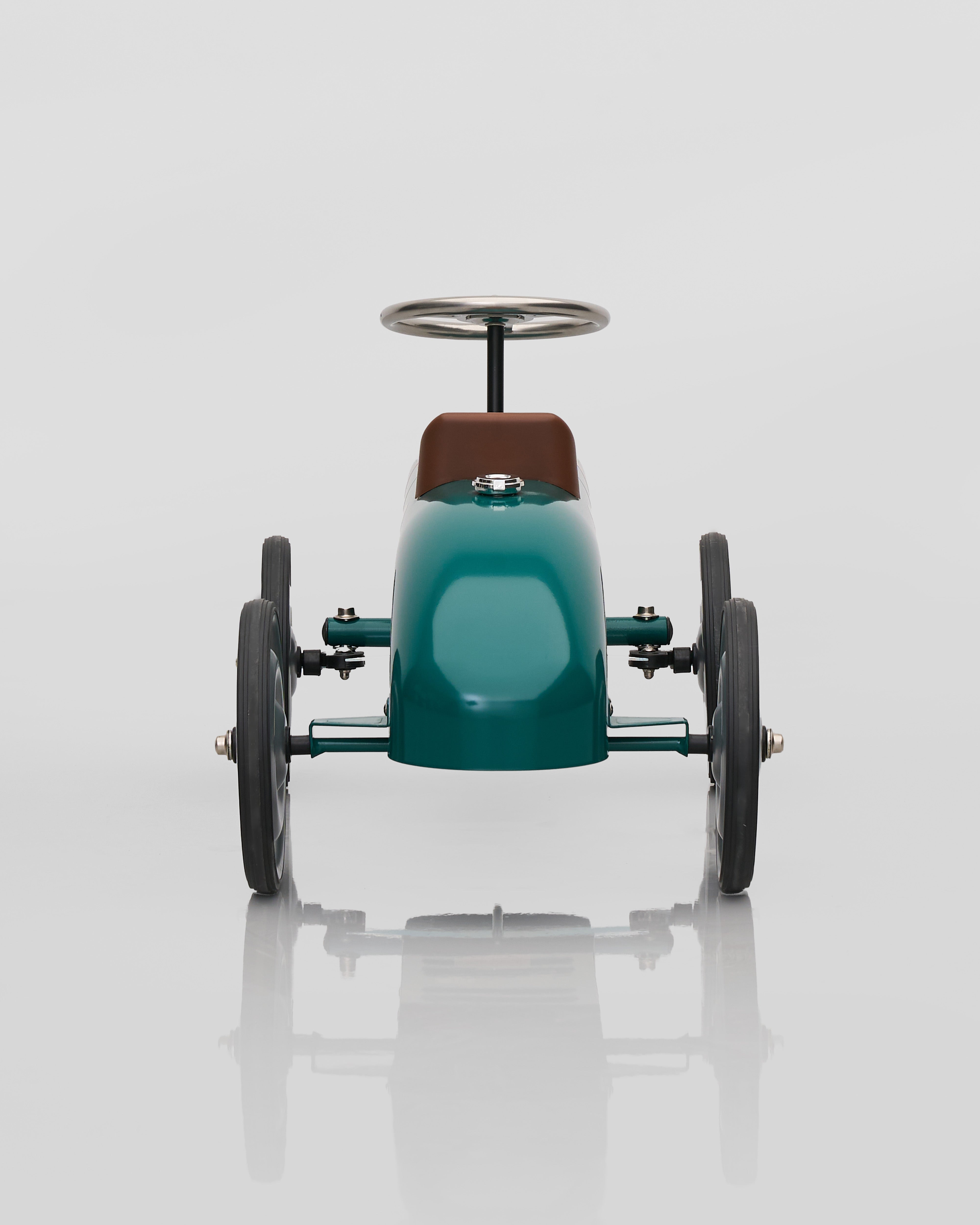 Model car with a teal body and brown top on a white background