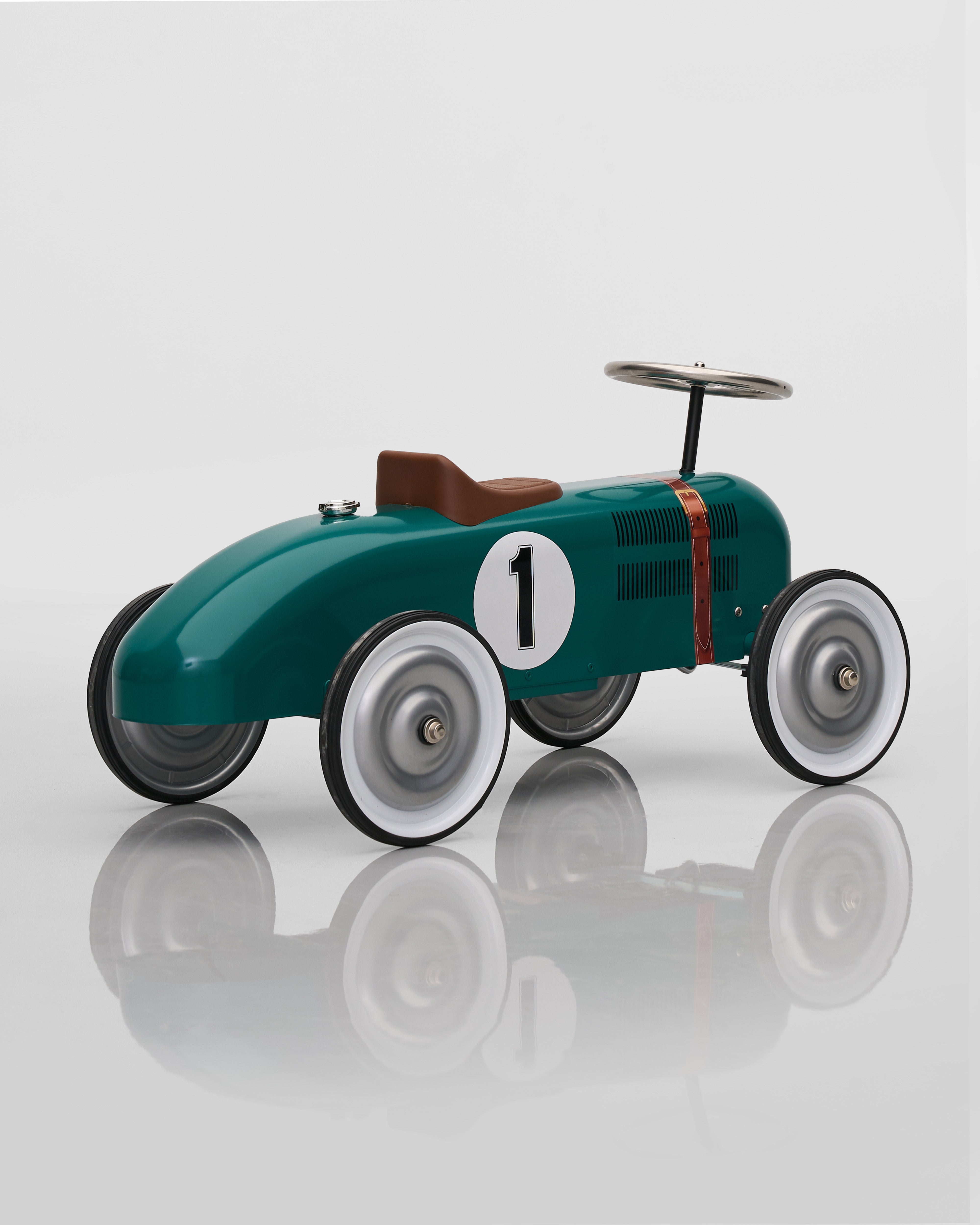 Vintage-style toy race car with number 1 on a reflective surface