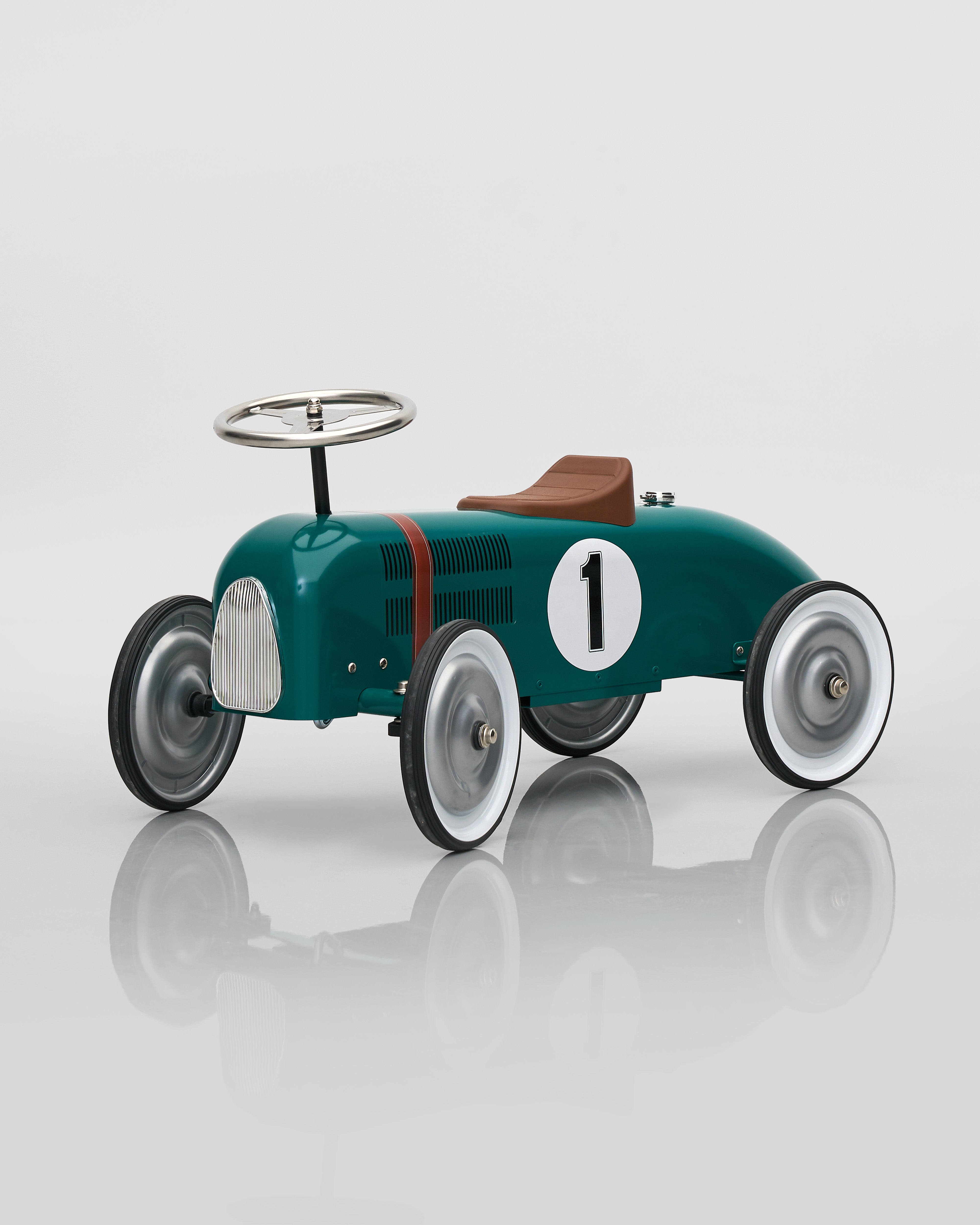 Vintage-style toy car with number 1 on a reflective surface
