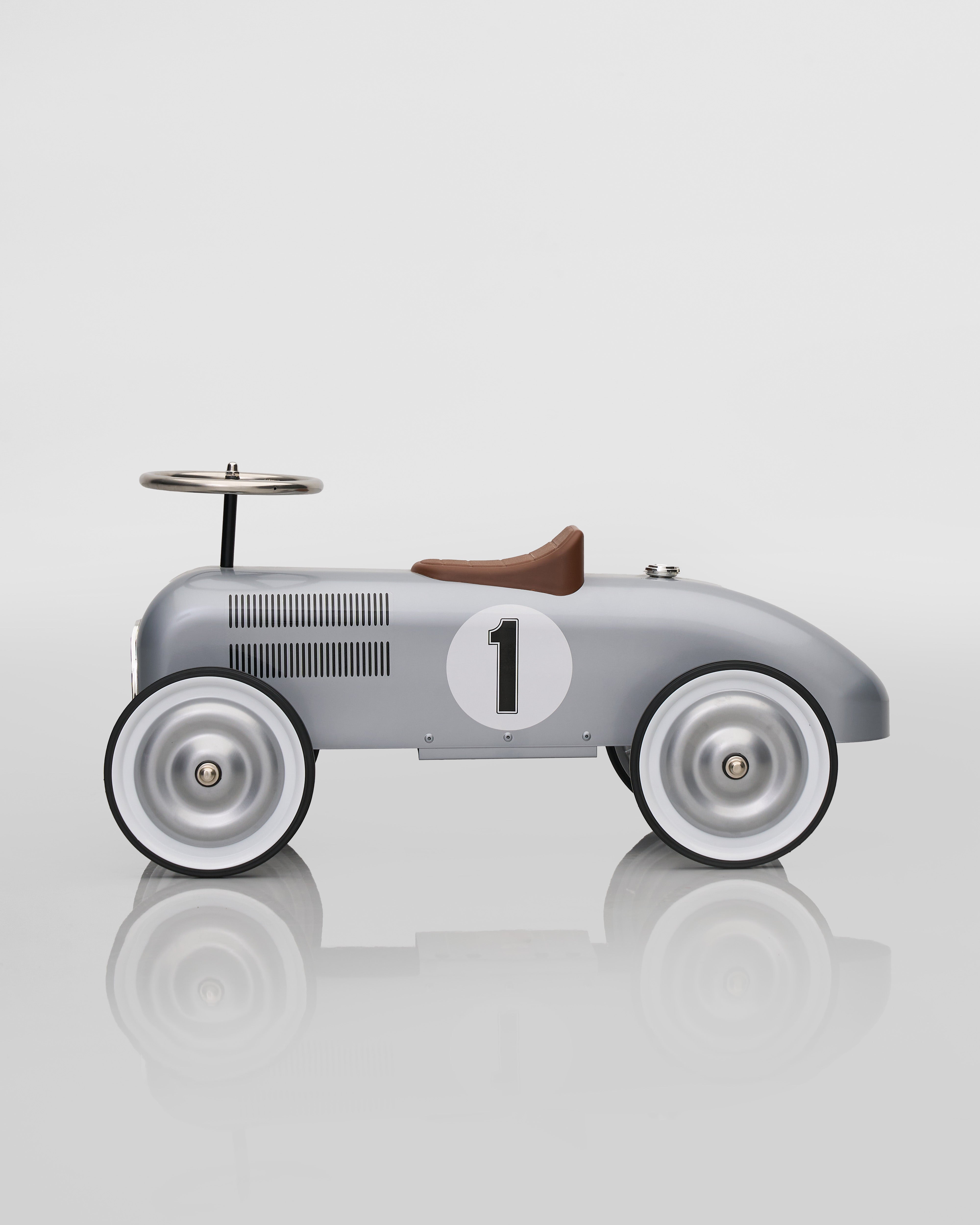 Vintage-style toy car with number 1 on a reflective surface