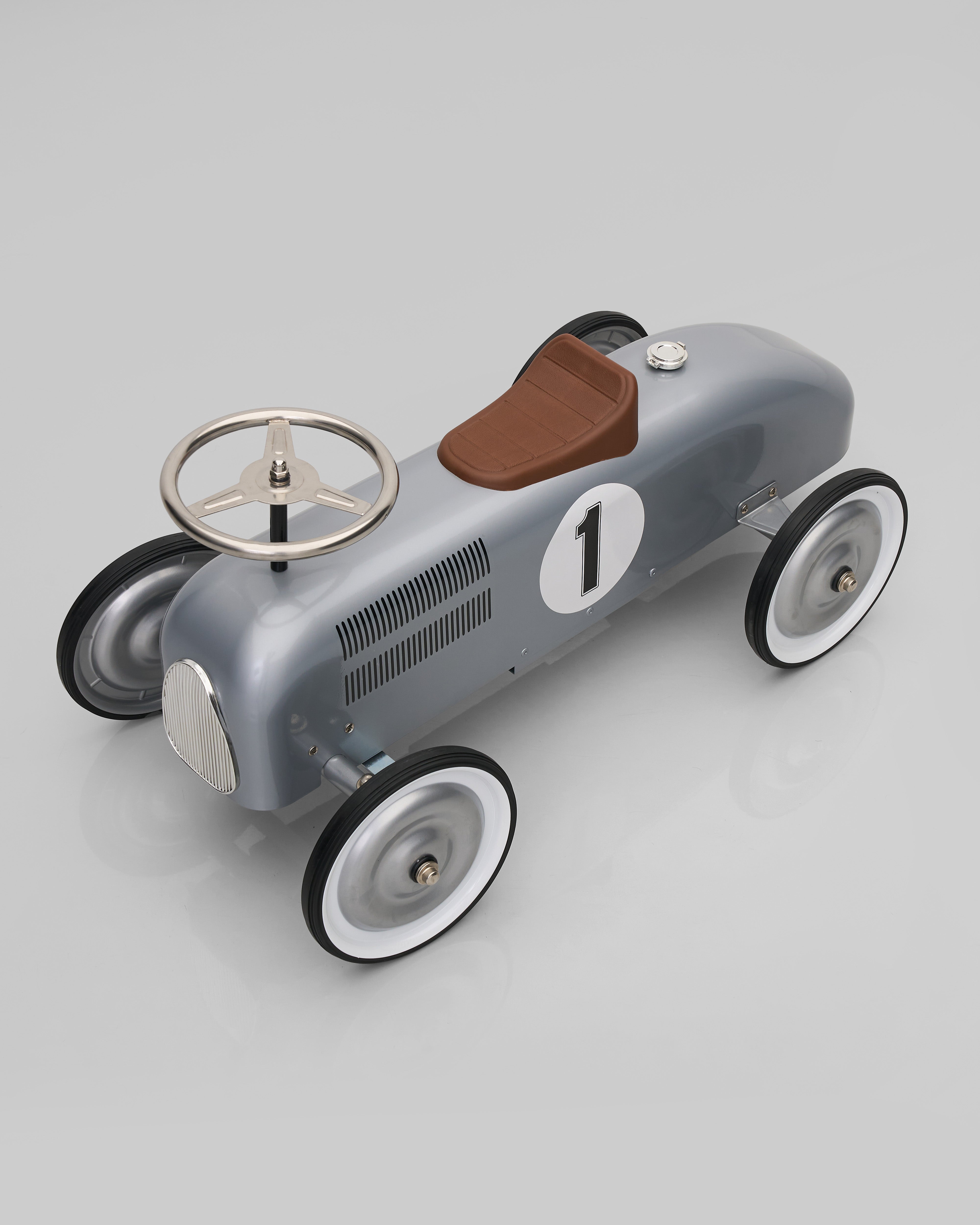 Vintage-style toy car with number 1 on a gray background