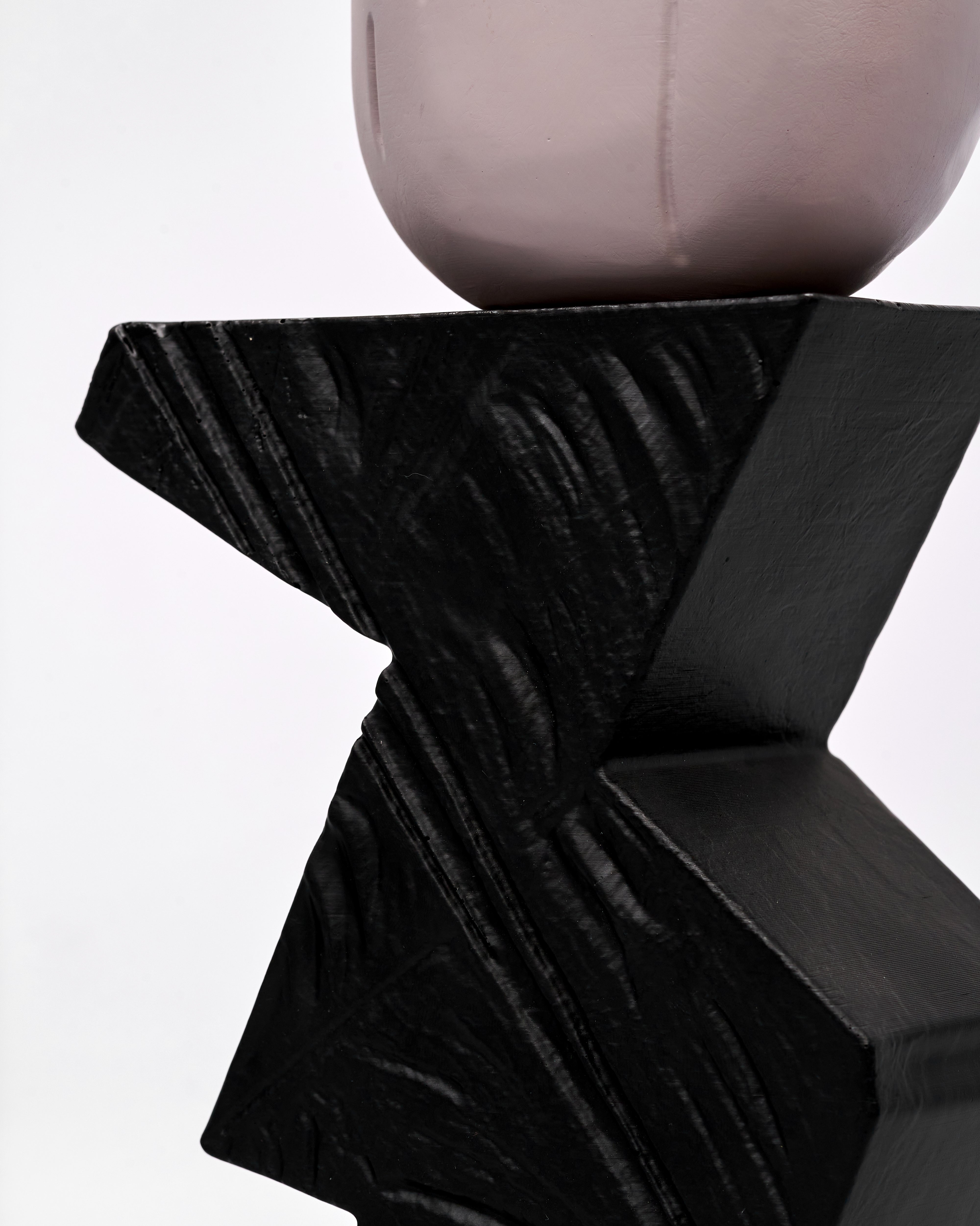 Black abstract sculpture on a white background
