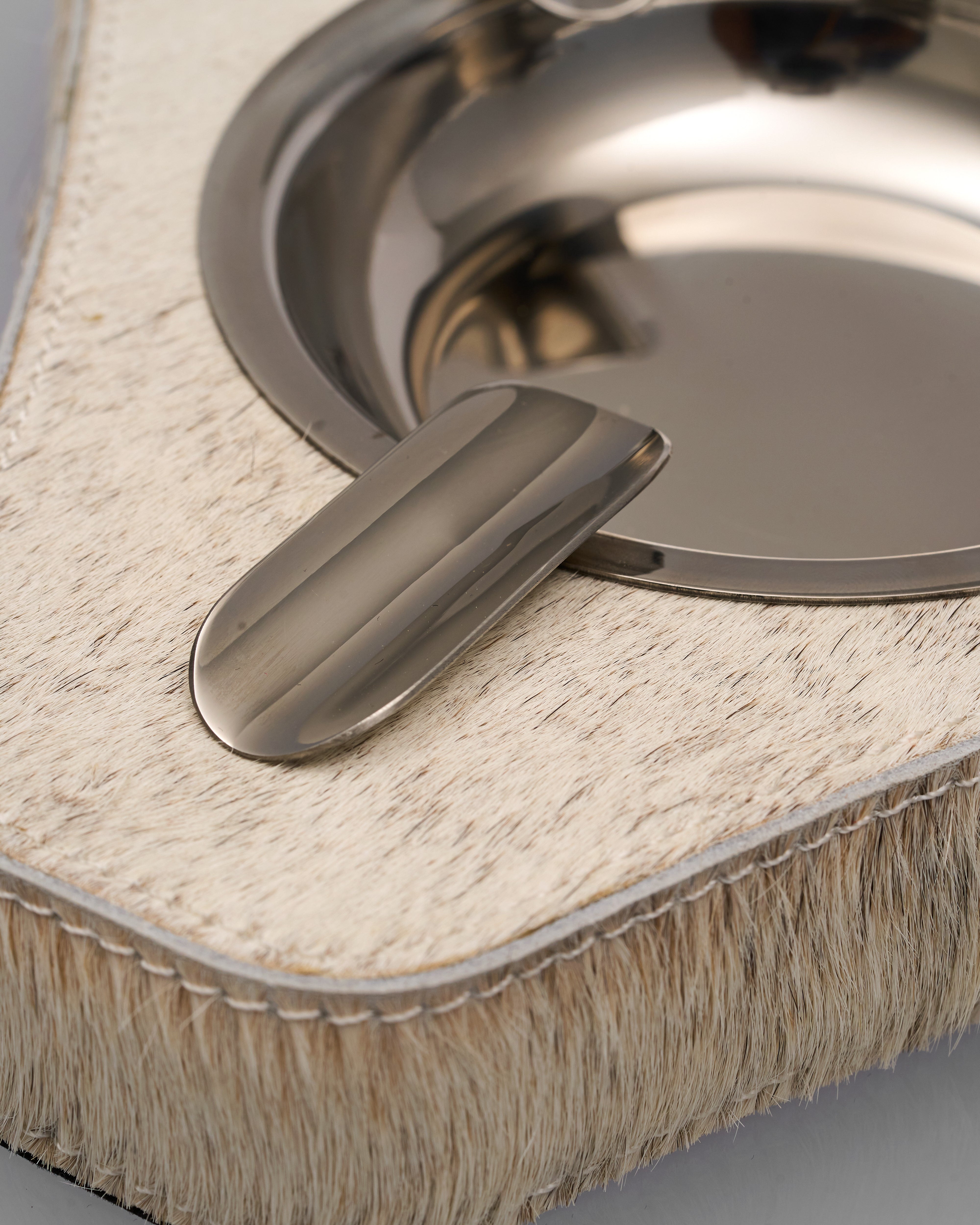 Metallic sink drain cover on a textured surface