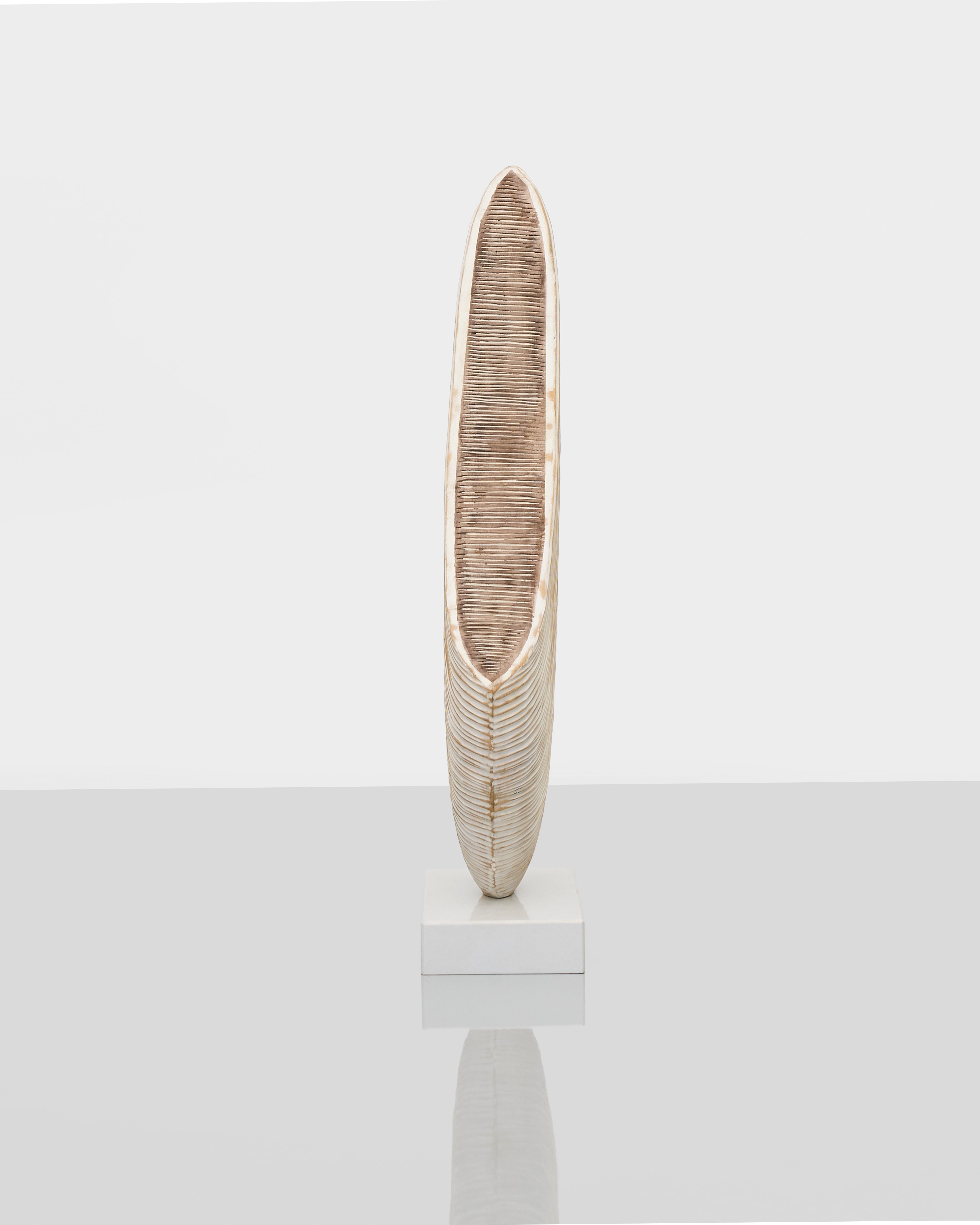 Decorative vase with wavy texture on a white background