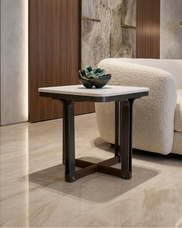 Modern living room with a side table, sofa, and abstract wall art.