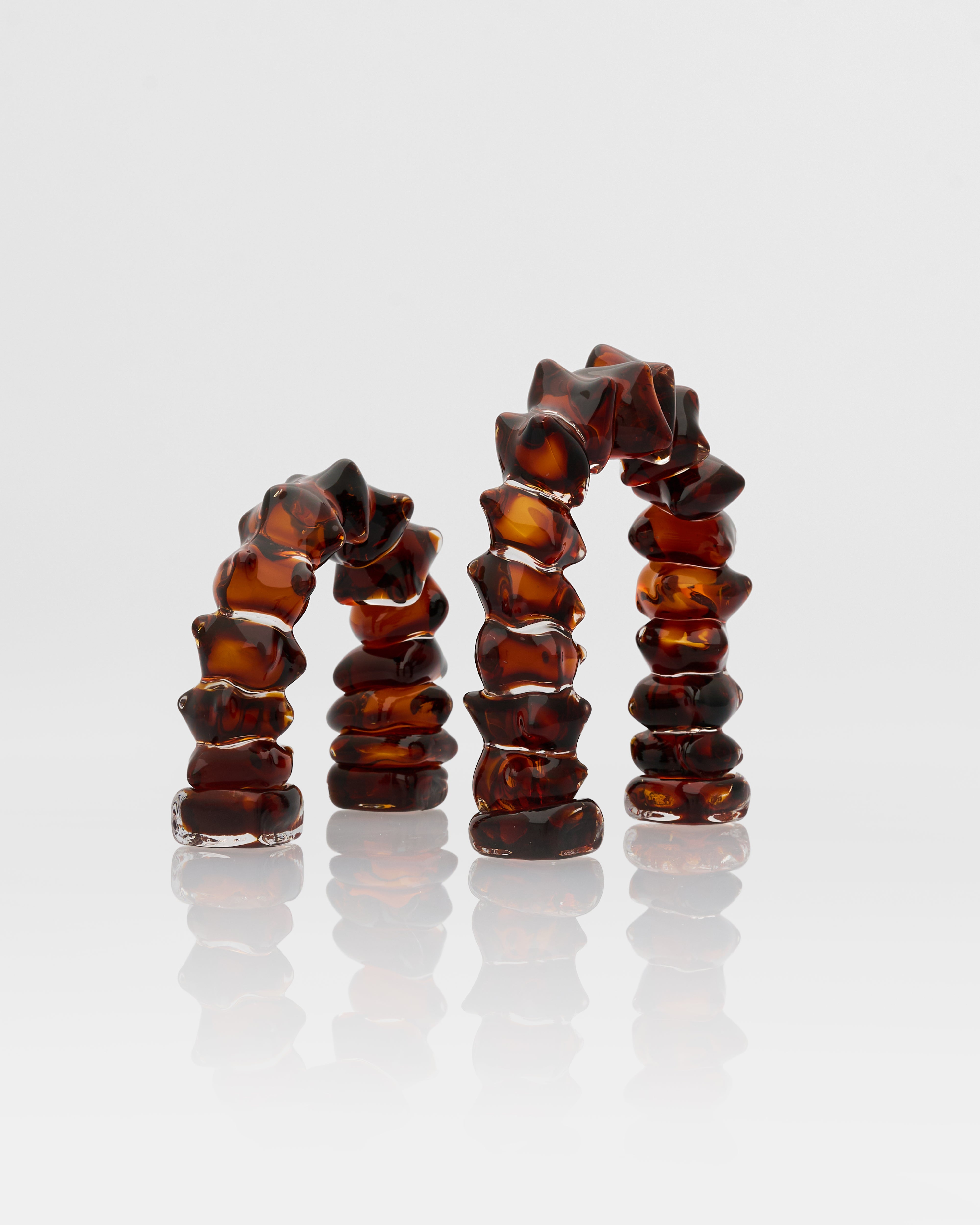 Close-up of Arc Ring Glass Decor Set detailing smooth glass texture and elegant beige-dark brown finish