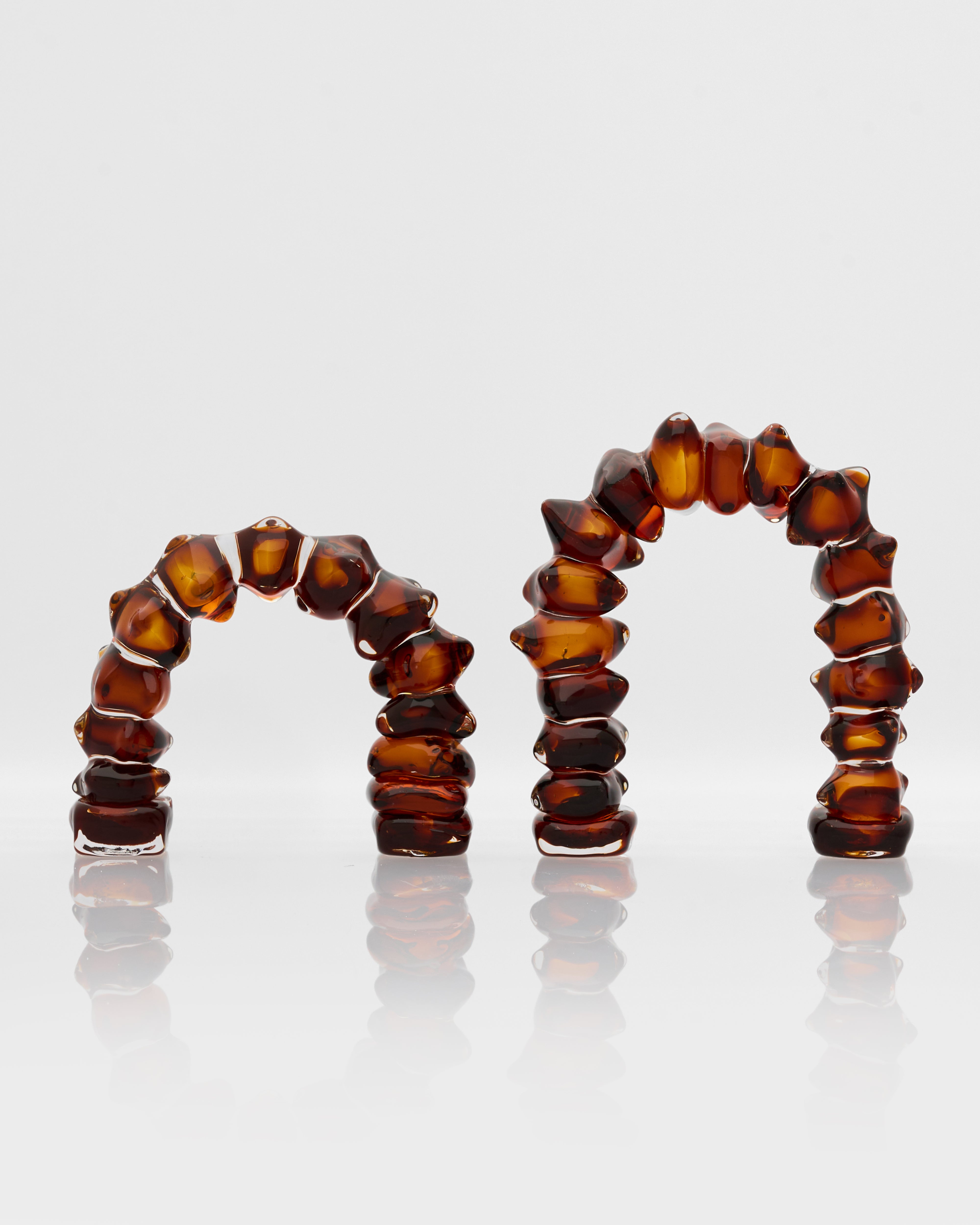 Set of amber-colored beaded rings on a white background