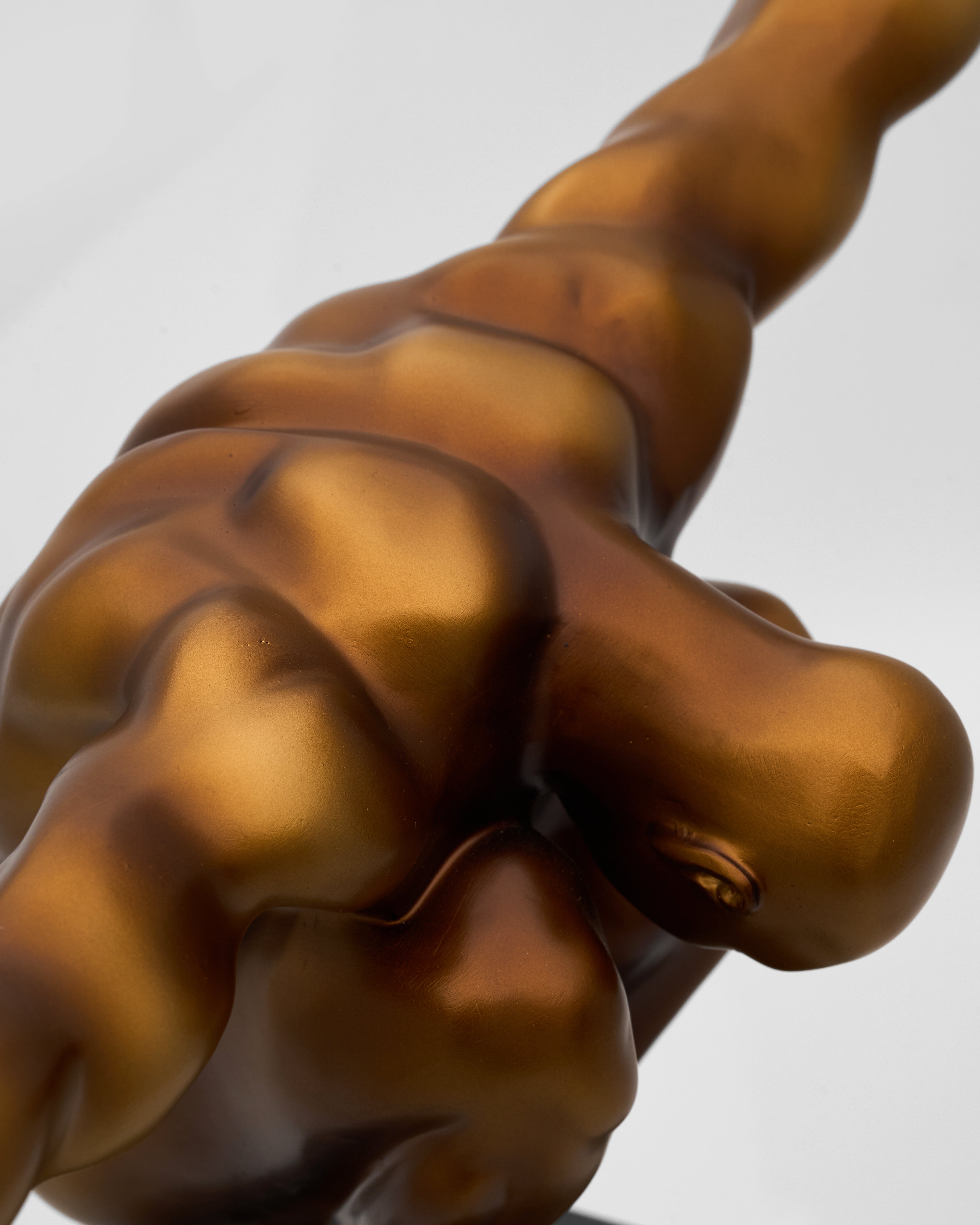 Detailed view of athletic male posture sculpture emphasizing anatomical form and sculptural elegance