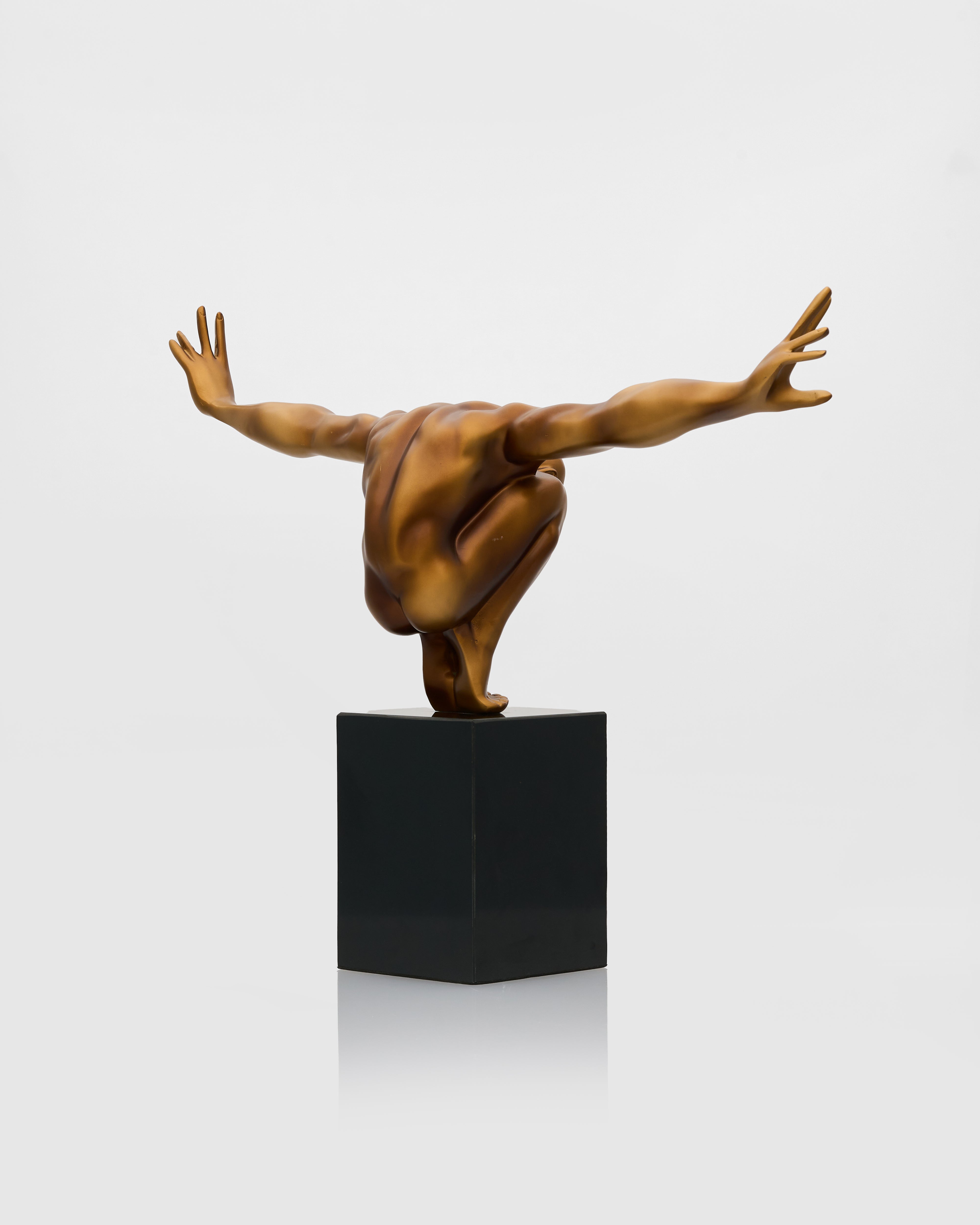 Side view of athletic male posture sculpture highlighting balanced stance and refined sculptural detailing