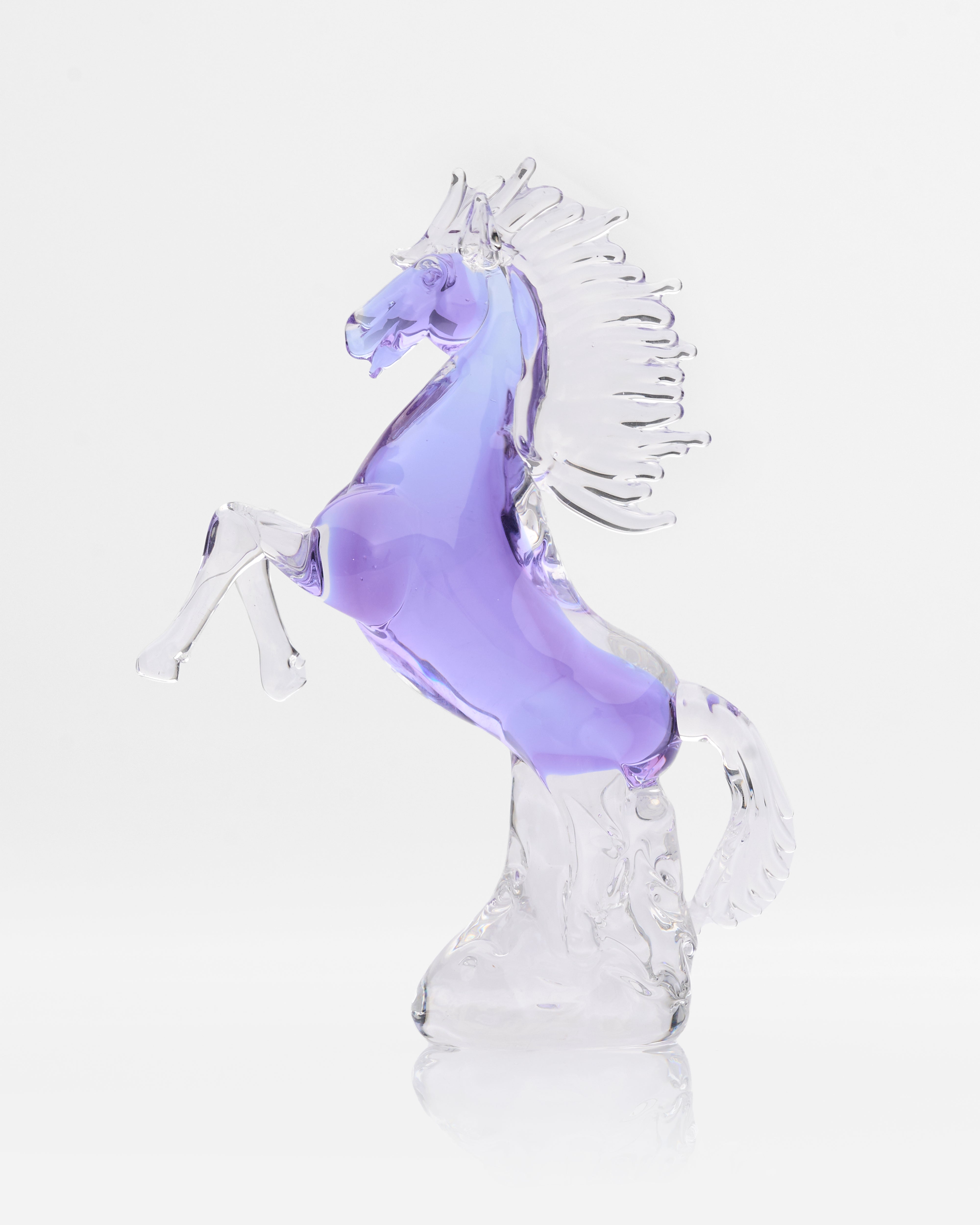 Glass horse sculpture with a purple body on a white background