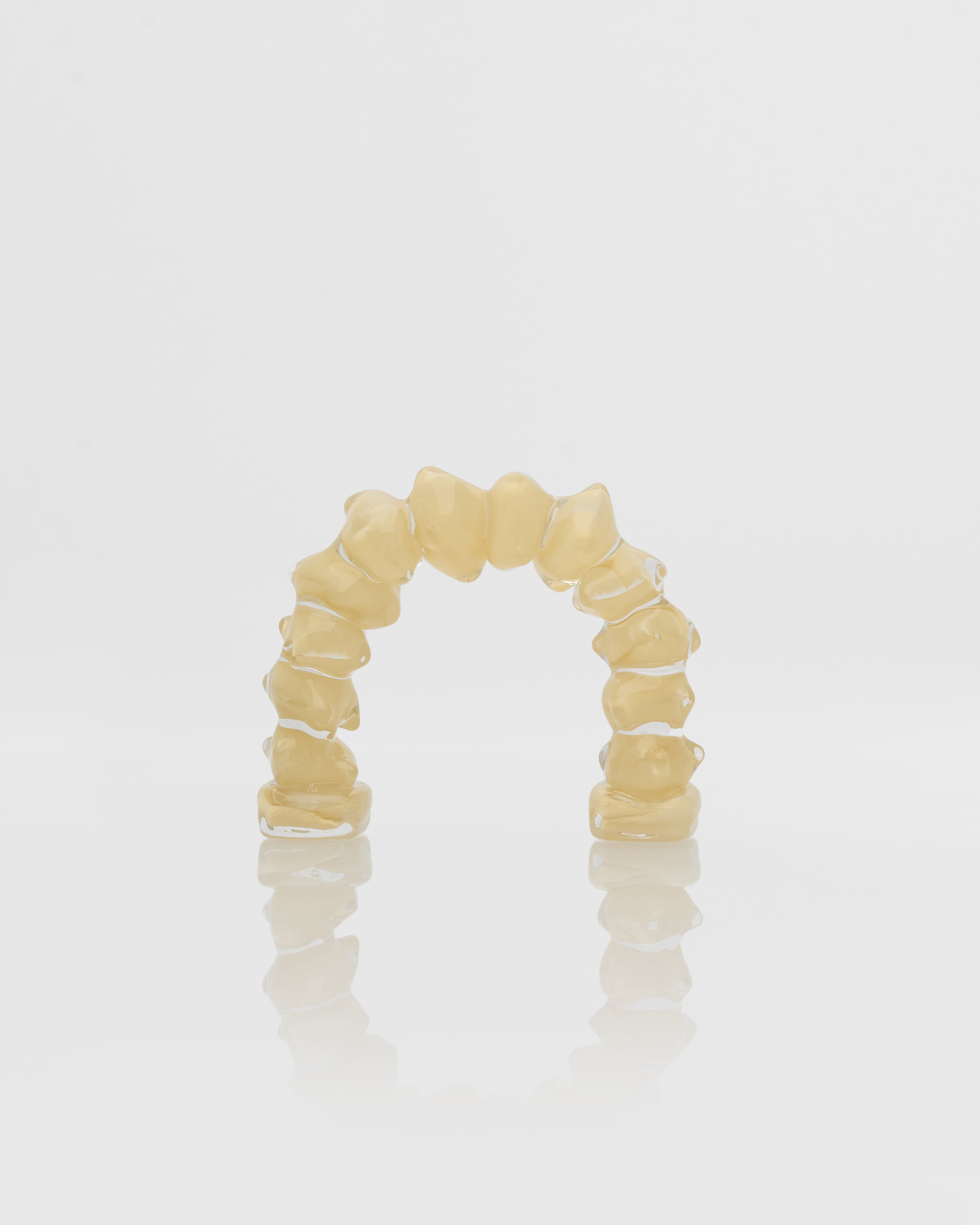 Beige marble ring decor with a unique design on a light gray background