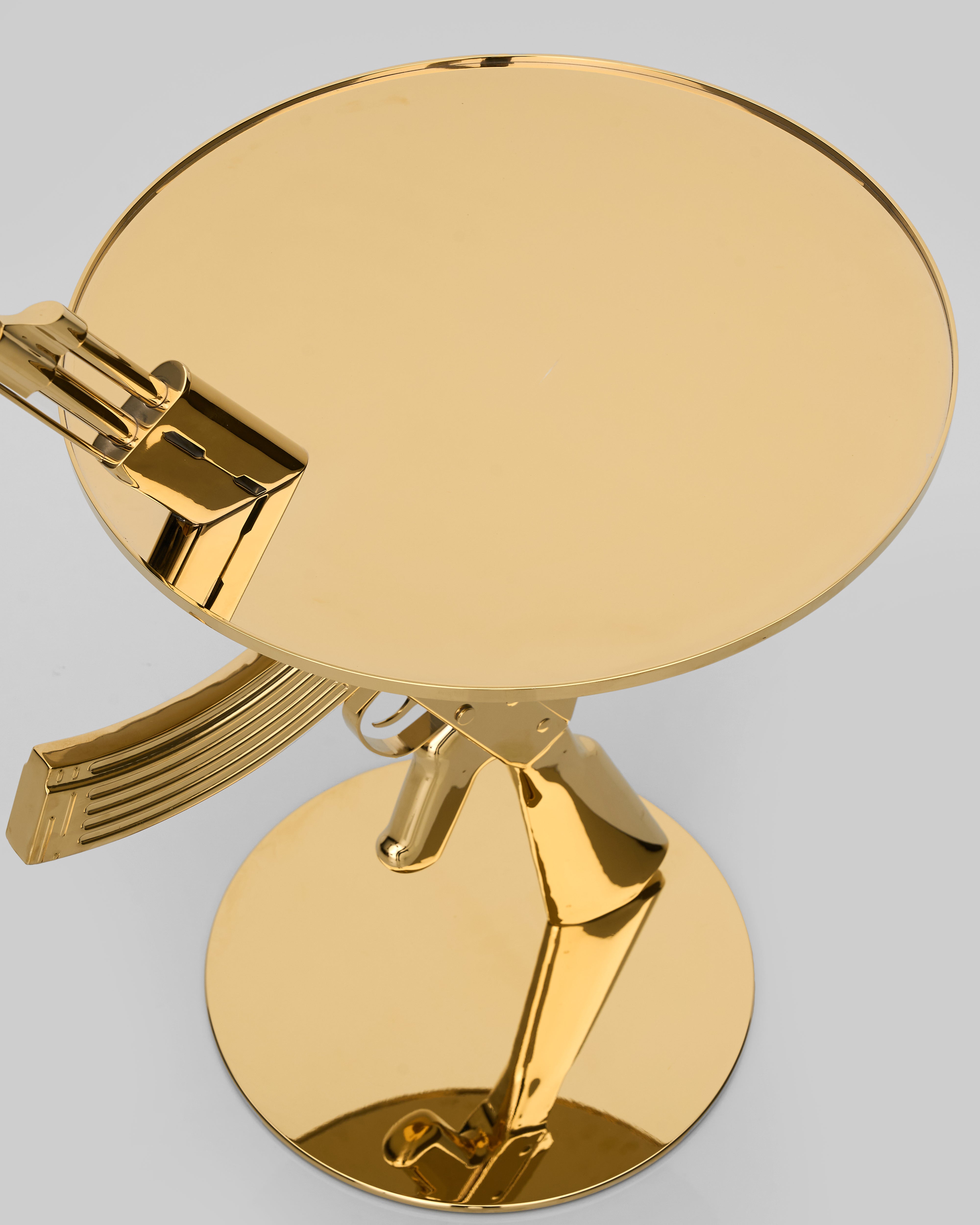 Close-up of Bolt Side Table detailing rifle-textured base and premium golden craftsmanship