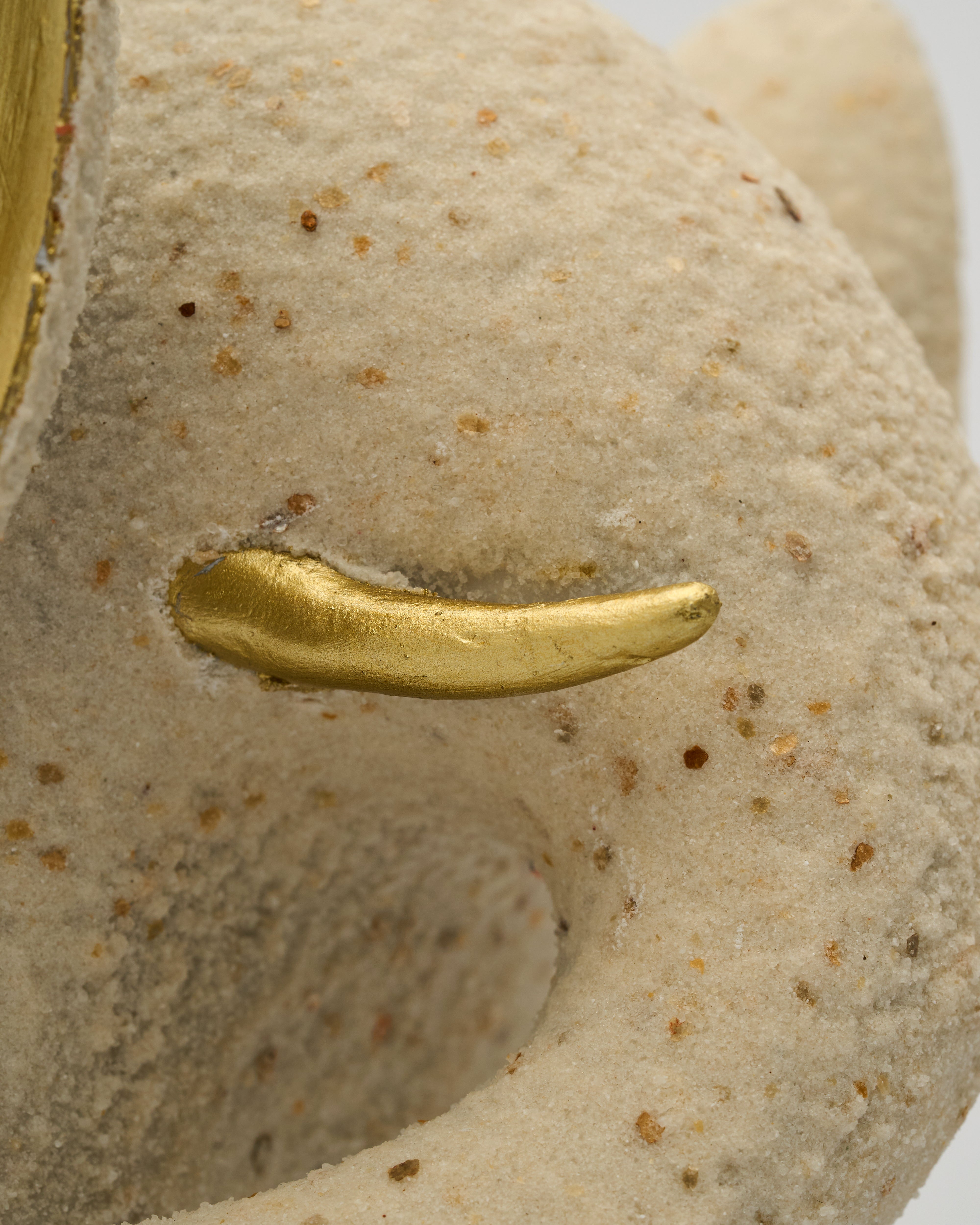Gold ring on a textured stone surface