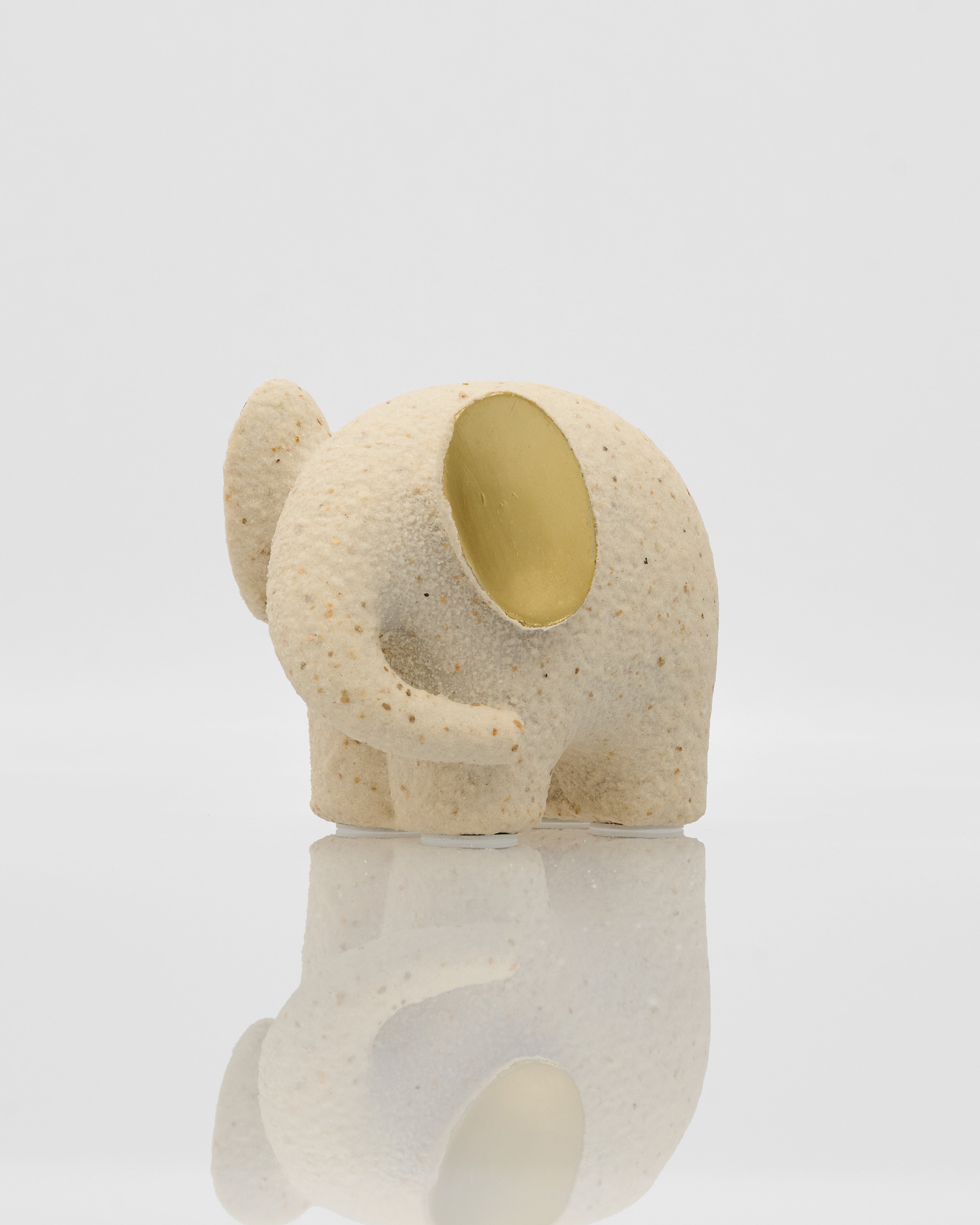 Ceramic elephant-shaped object on a white background
