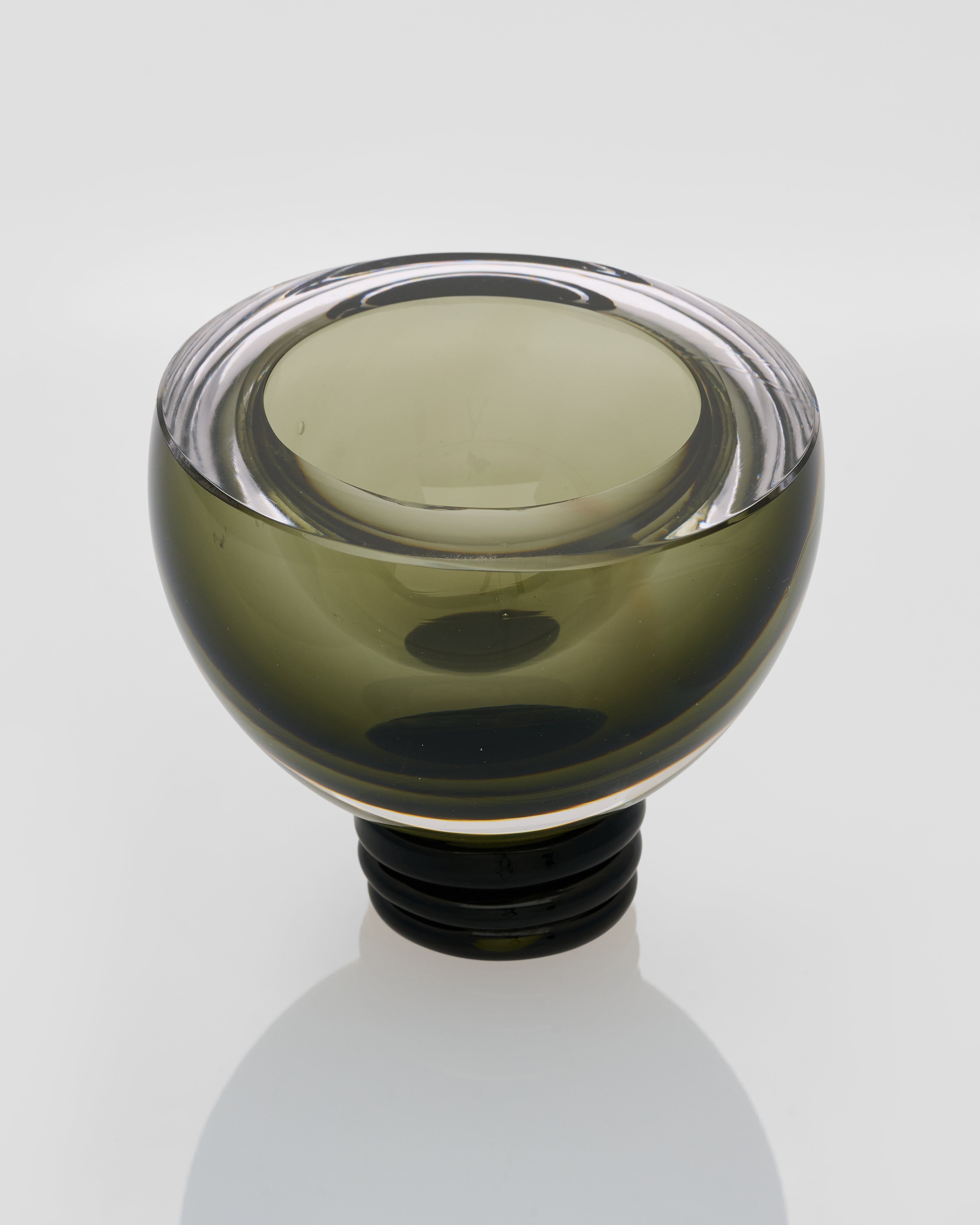 Side view of contemporary green round vase highlighting half-cut silhouette and elegant curly base
