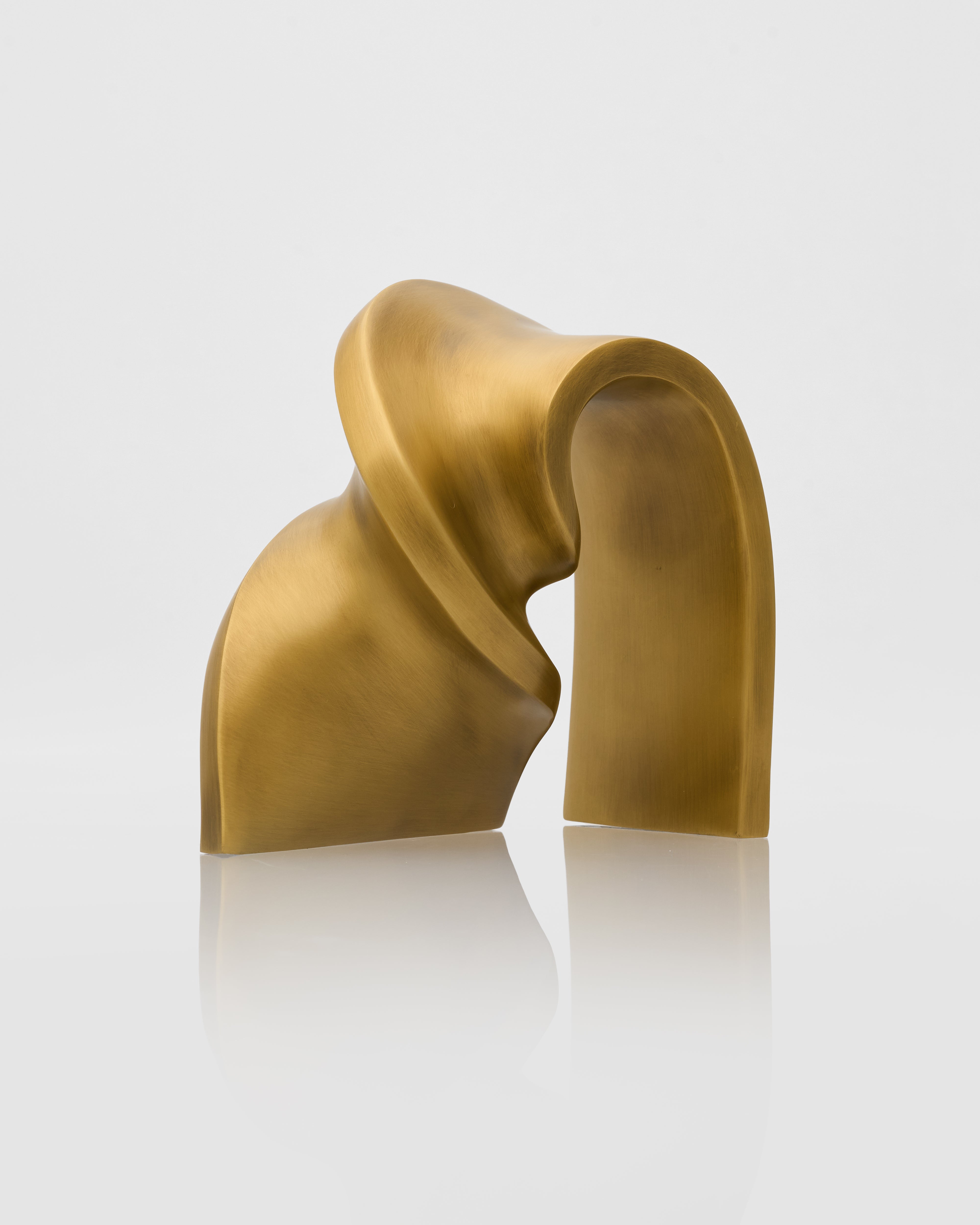 Gold abstract sculpture on a white background