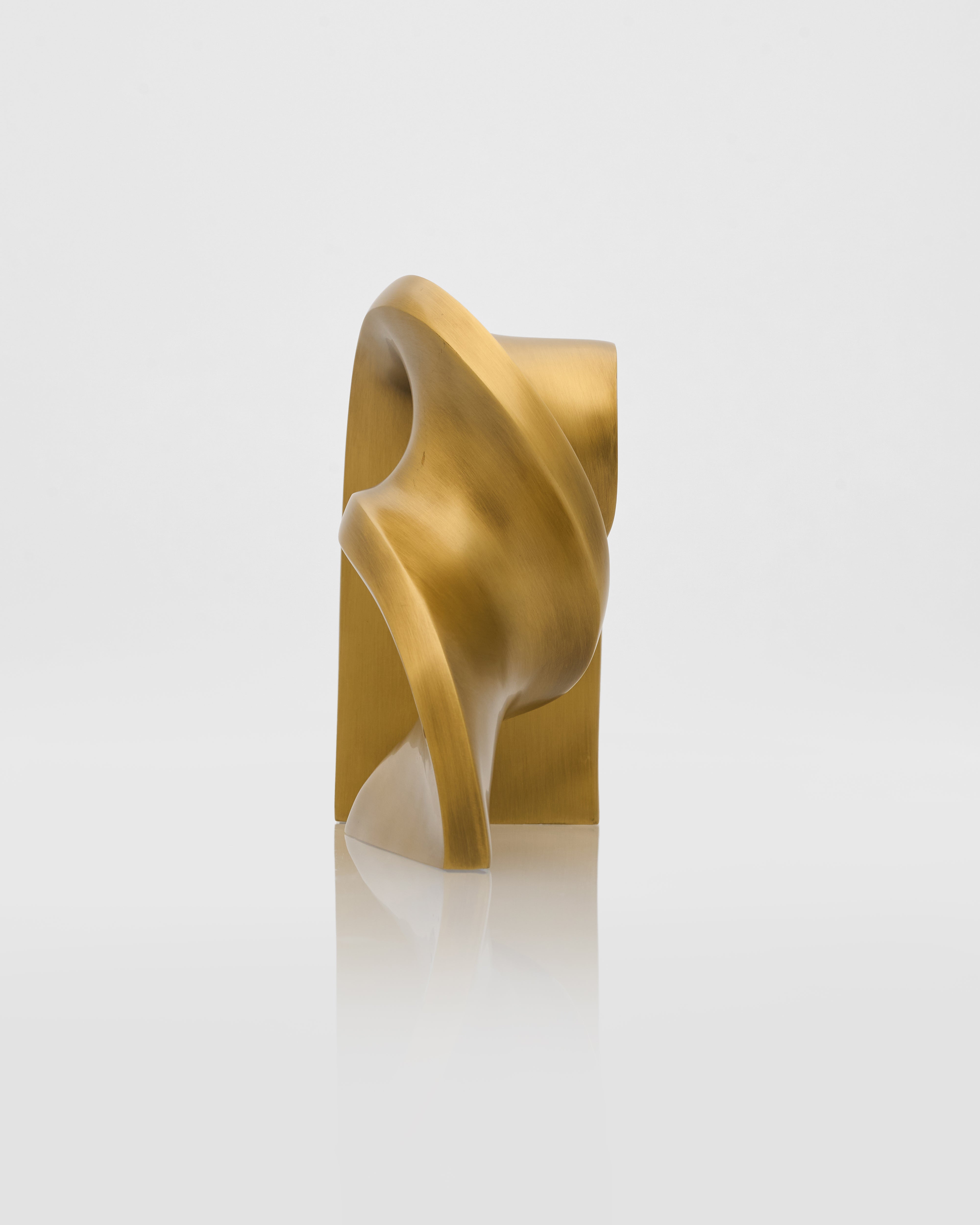 Gold-colored sculpture on a white background