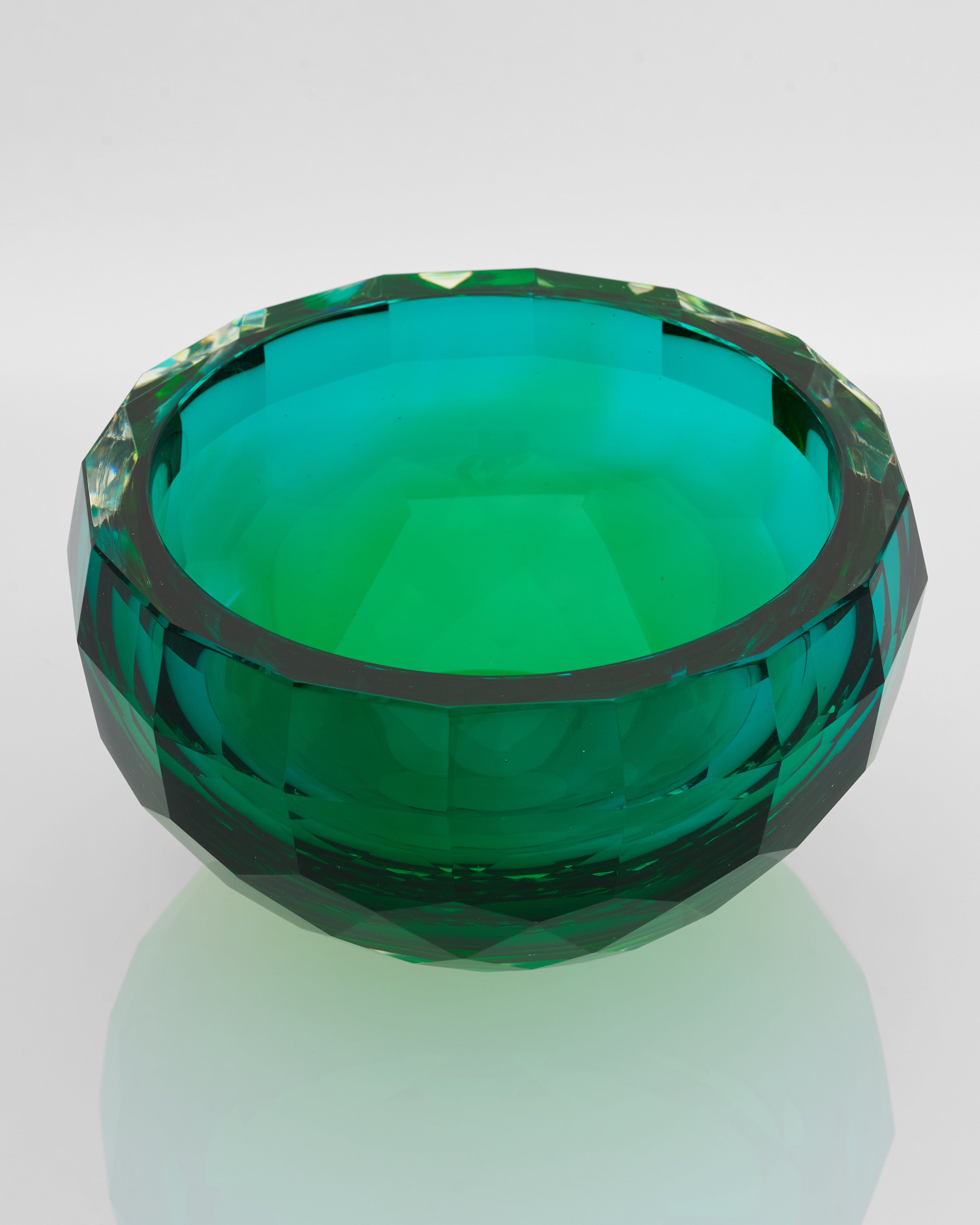 Green faceted bowl on a white background
