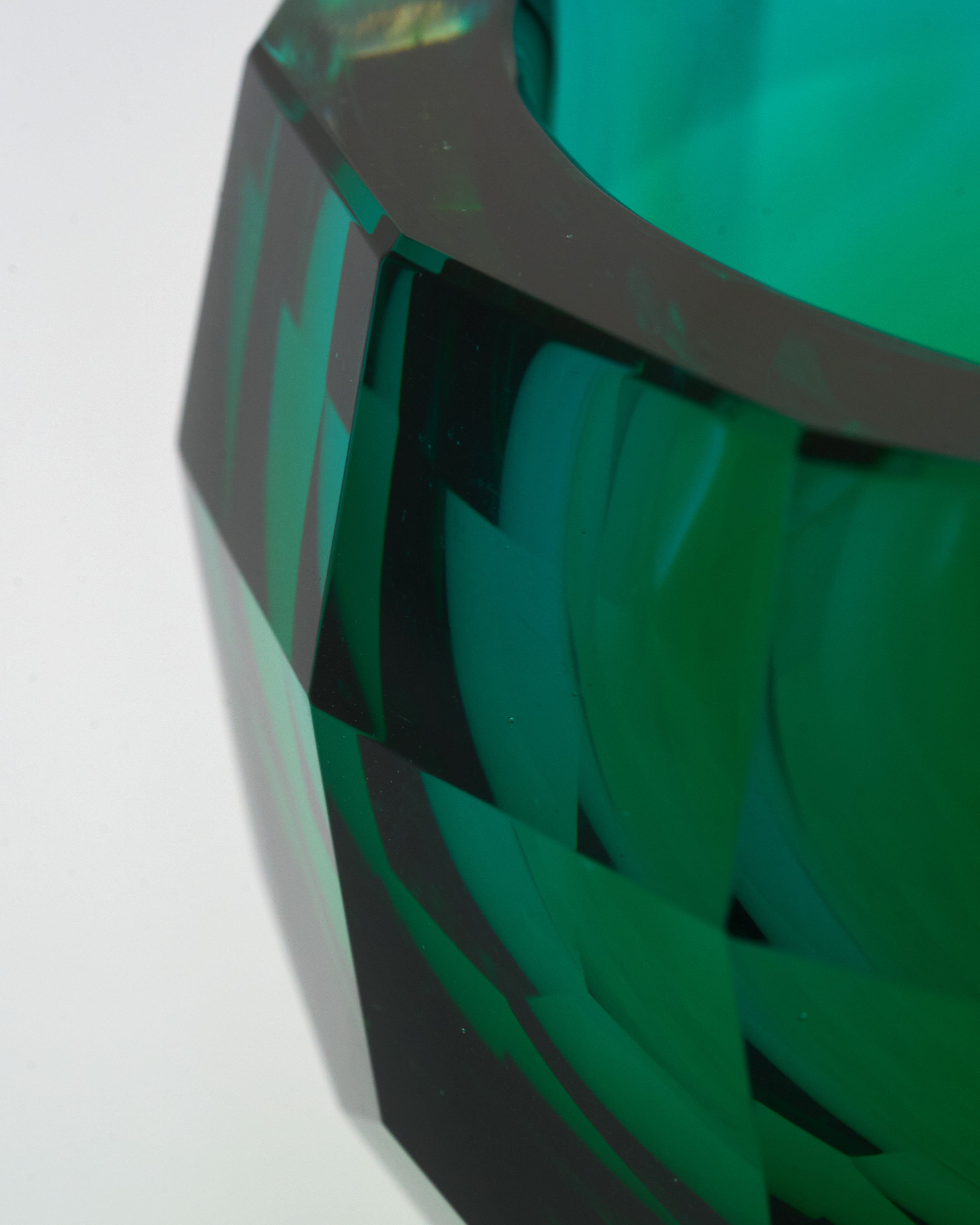 Close-up of a green and black woven basket on a white background