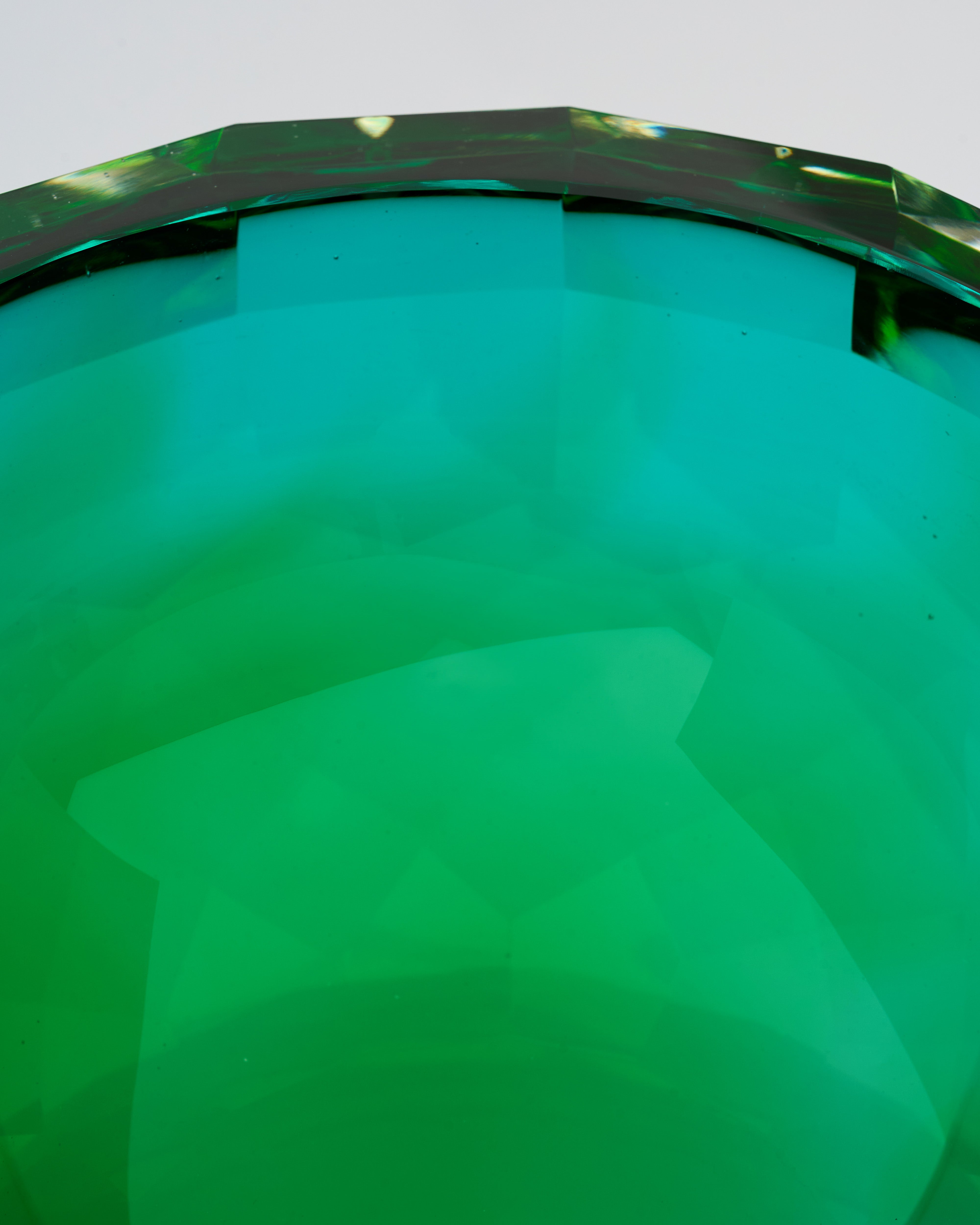 Close-up of crystal-cut green vase bowl highlighting smooth base and premium crystal craftsmanship