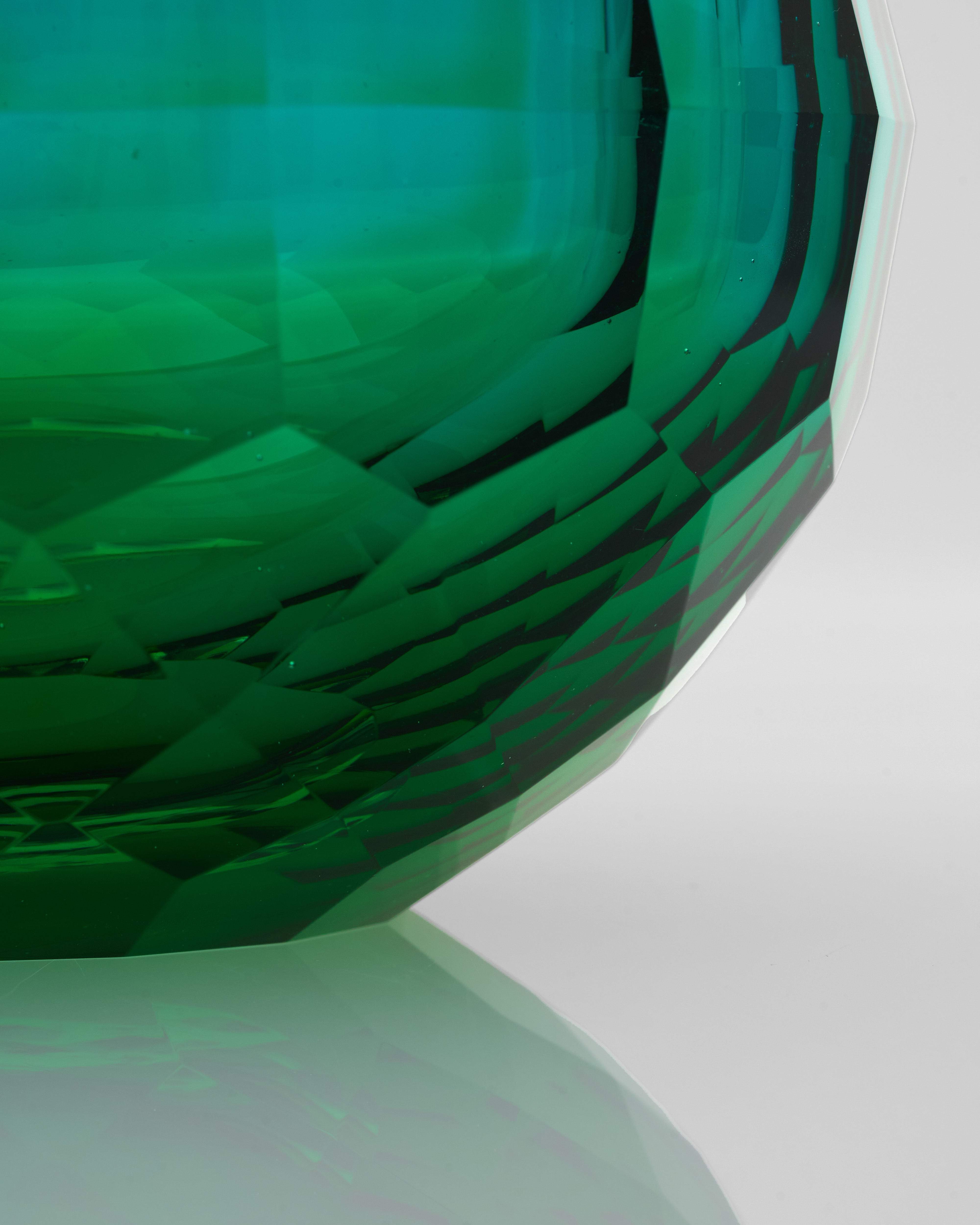 Close-up of a green and black geometric-patterned object on a white background