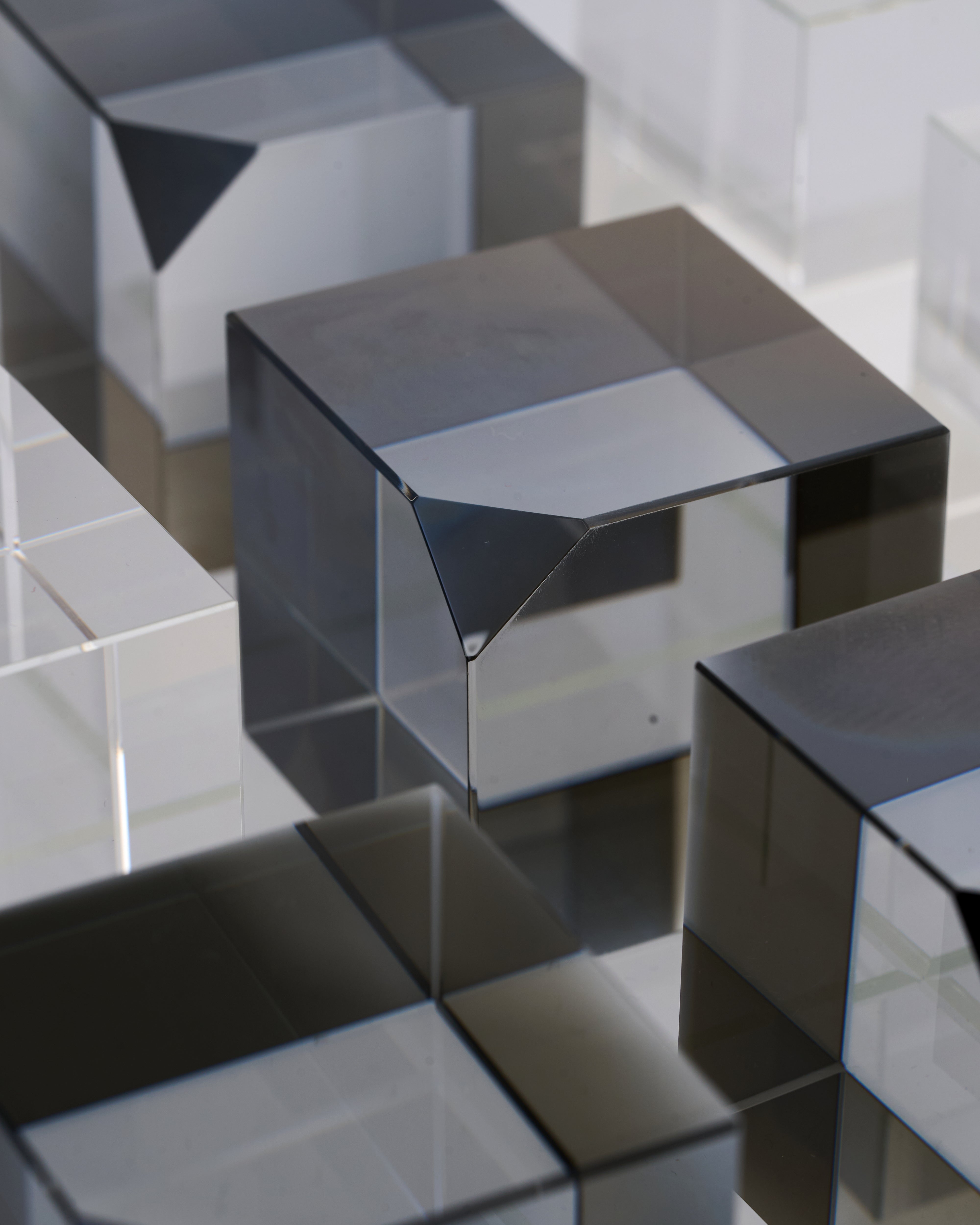 Close-up of reflective black cubes creating a geometric pattern of tic tac toe game