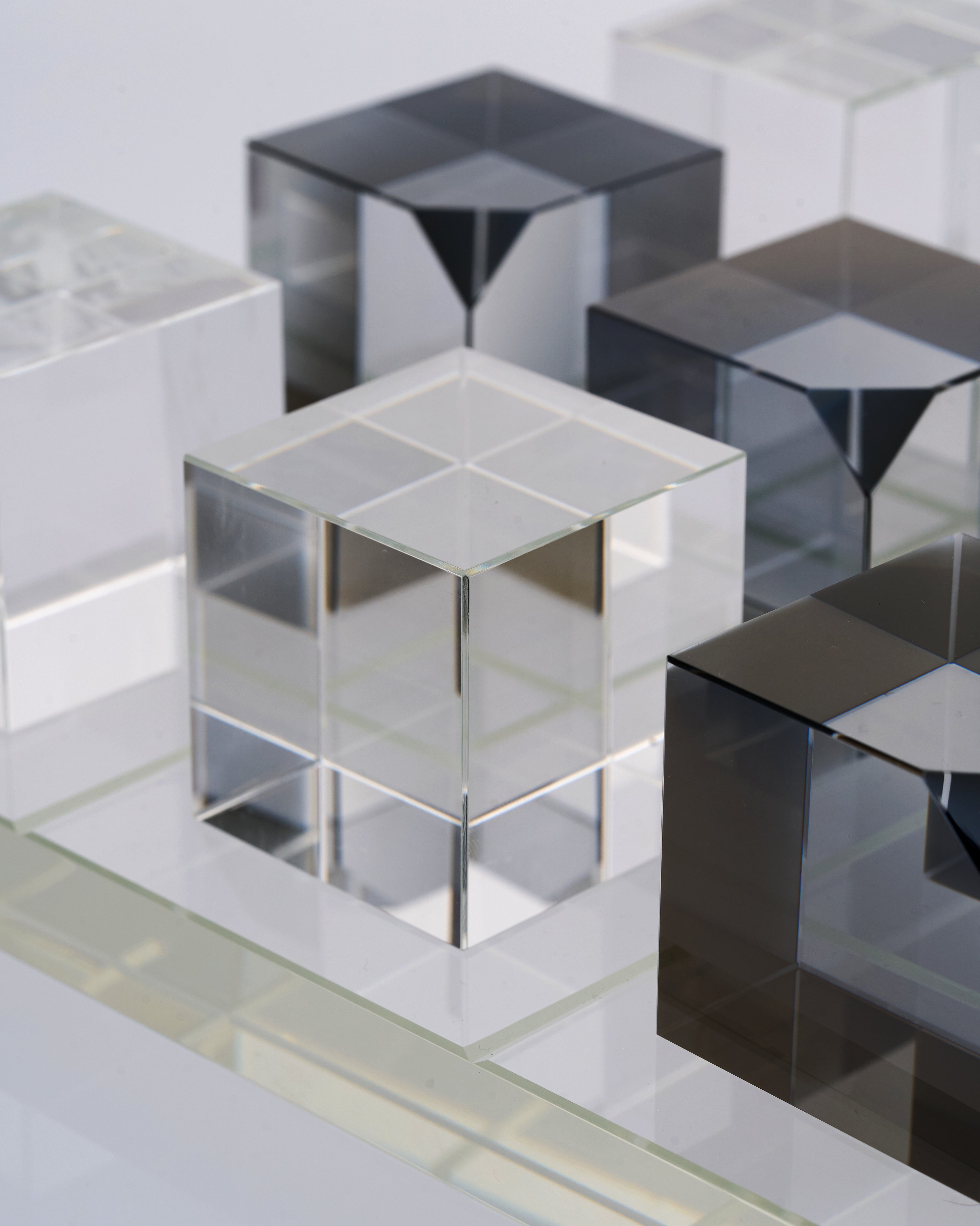 Set of reflective metallic cubes on a light gray background