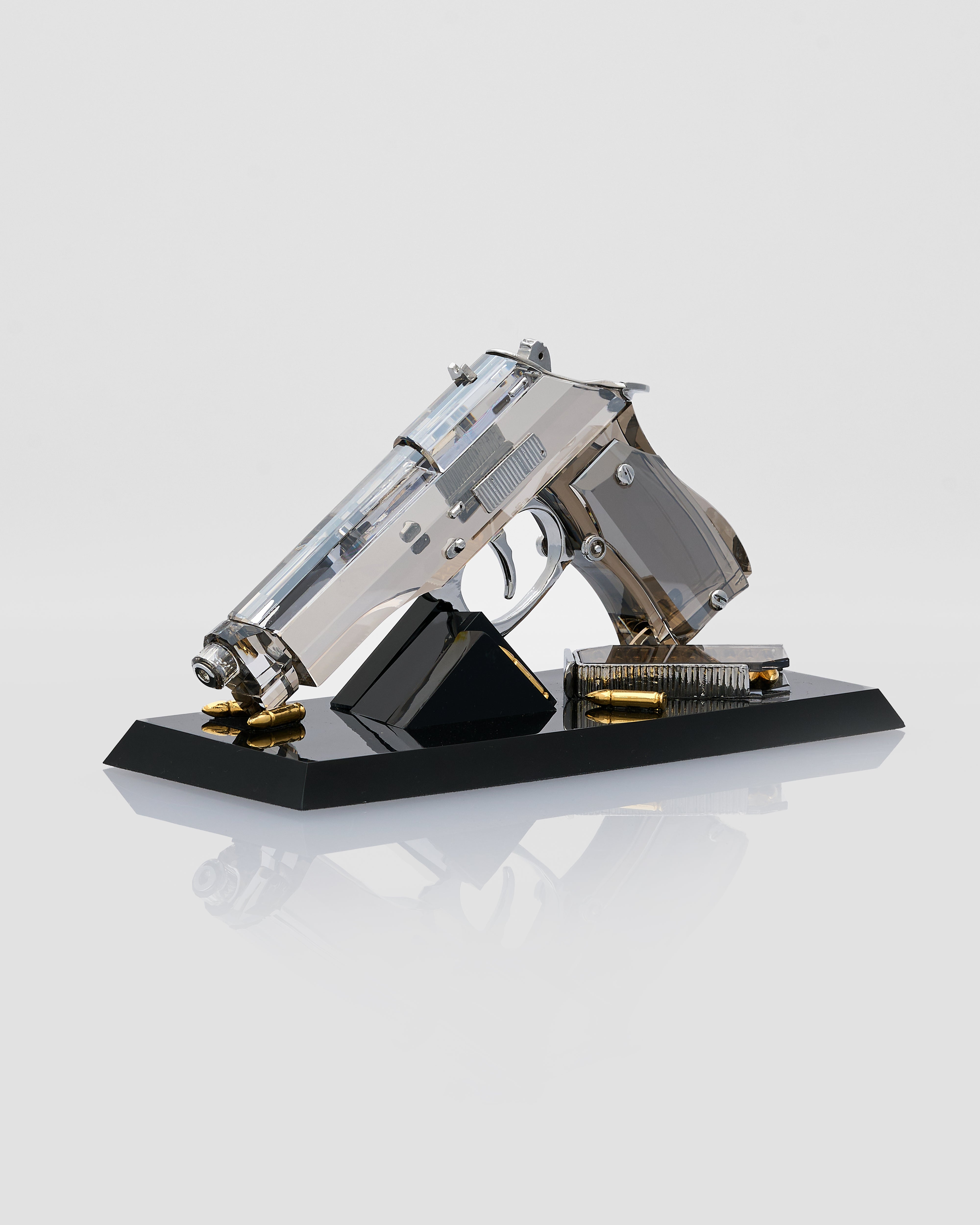 transparent crystal handgun model on a black stand