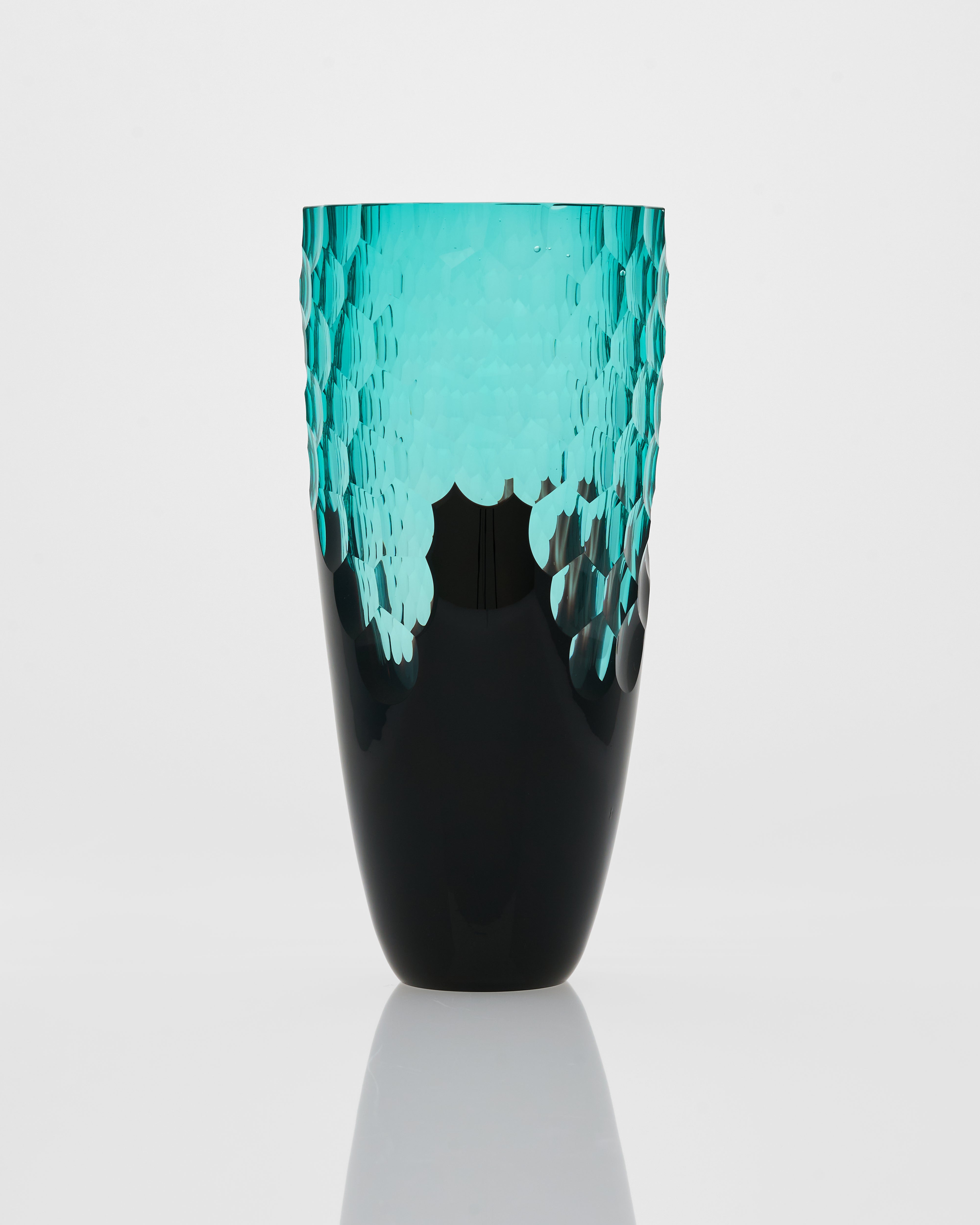 Vase with turquoise top and black bottom on a white background