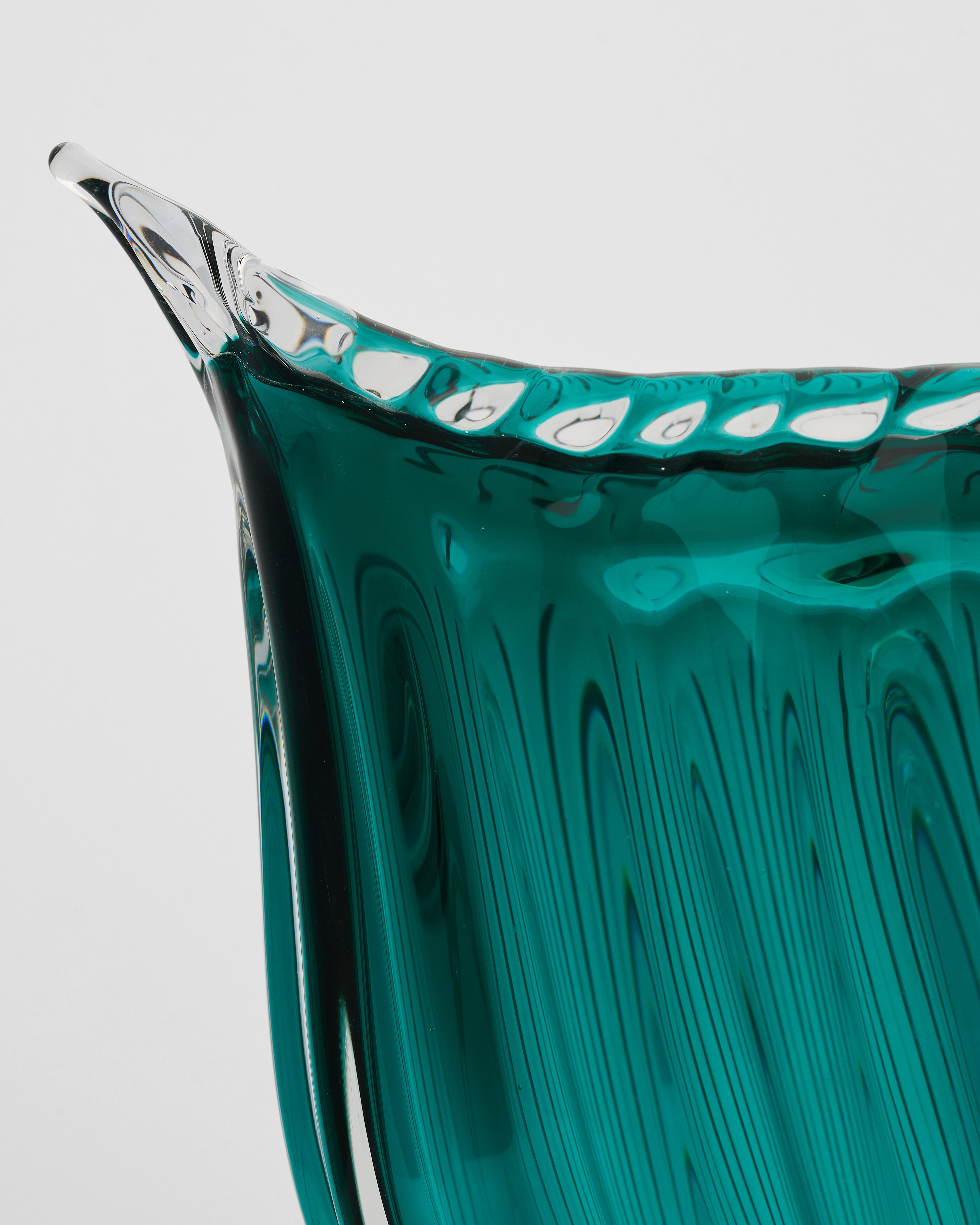 Close-up of cyan crystal glass tail vase highlighting luminous finish and refined detailing