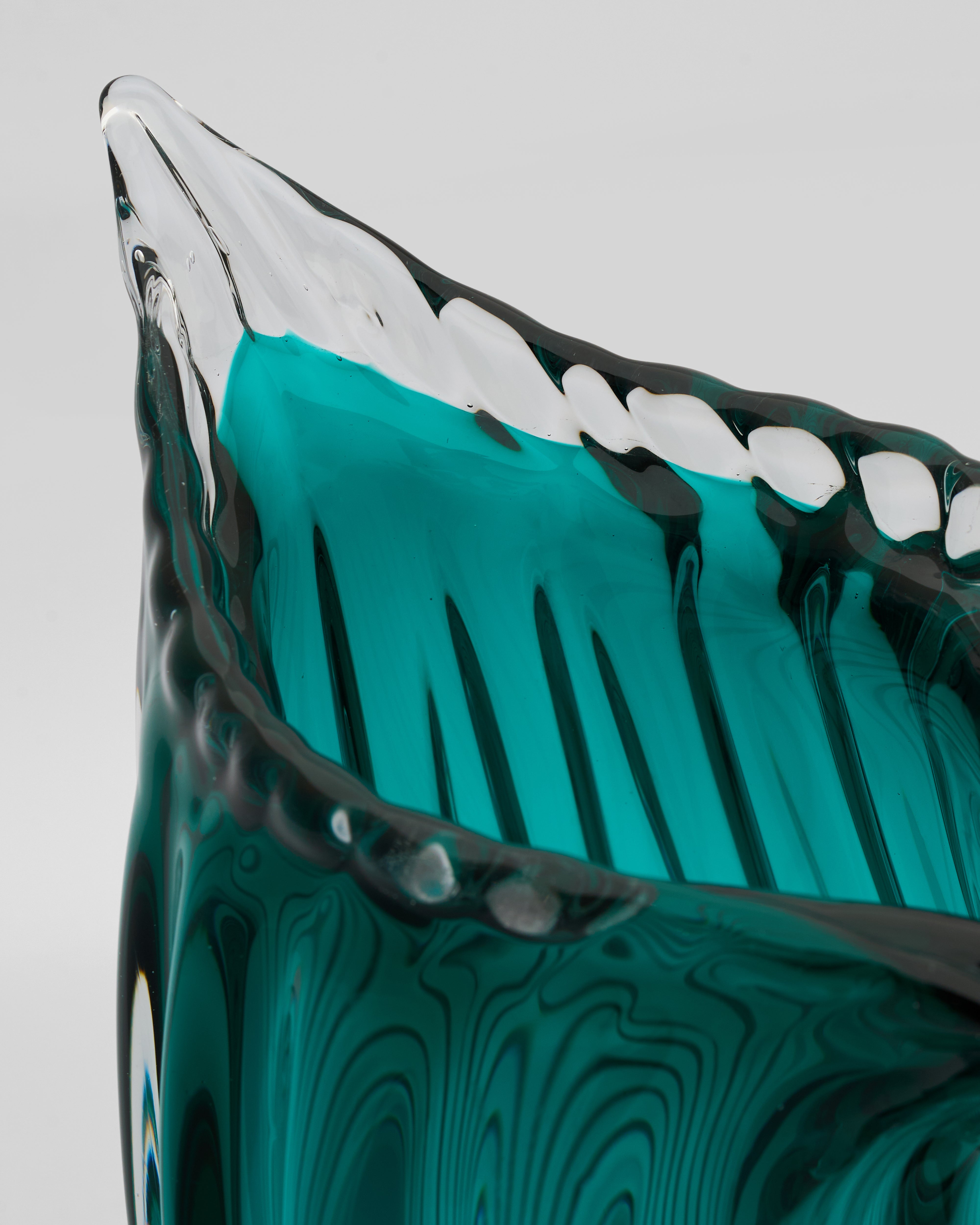Detailed view of cyan crystal glass tail vase emphasizing curved rim and artistic tail base design