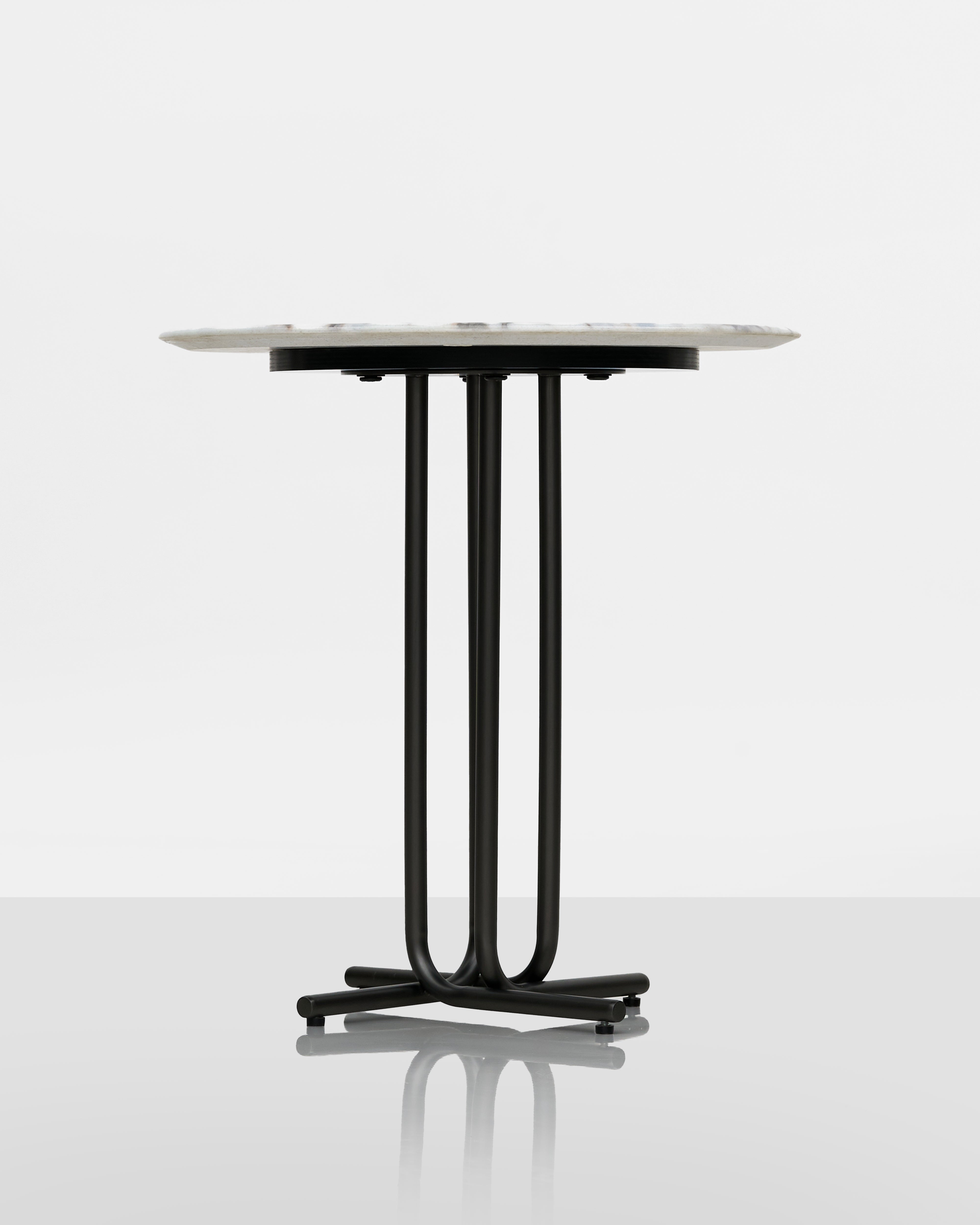 Round table with a black metal base on a white background