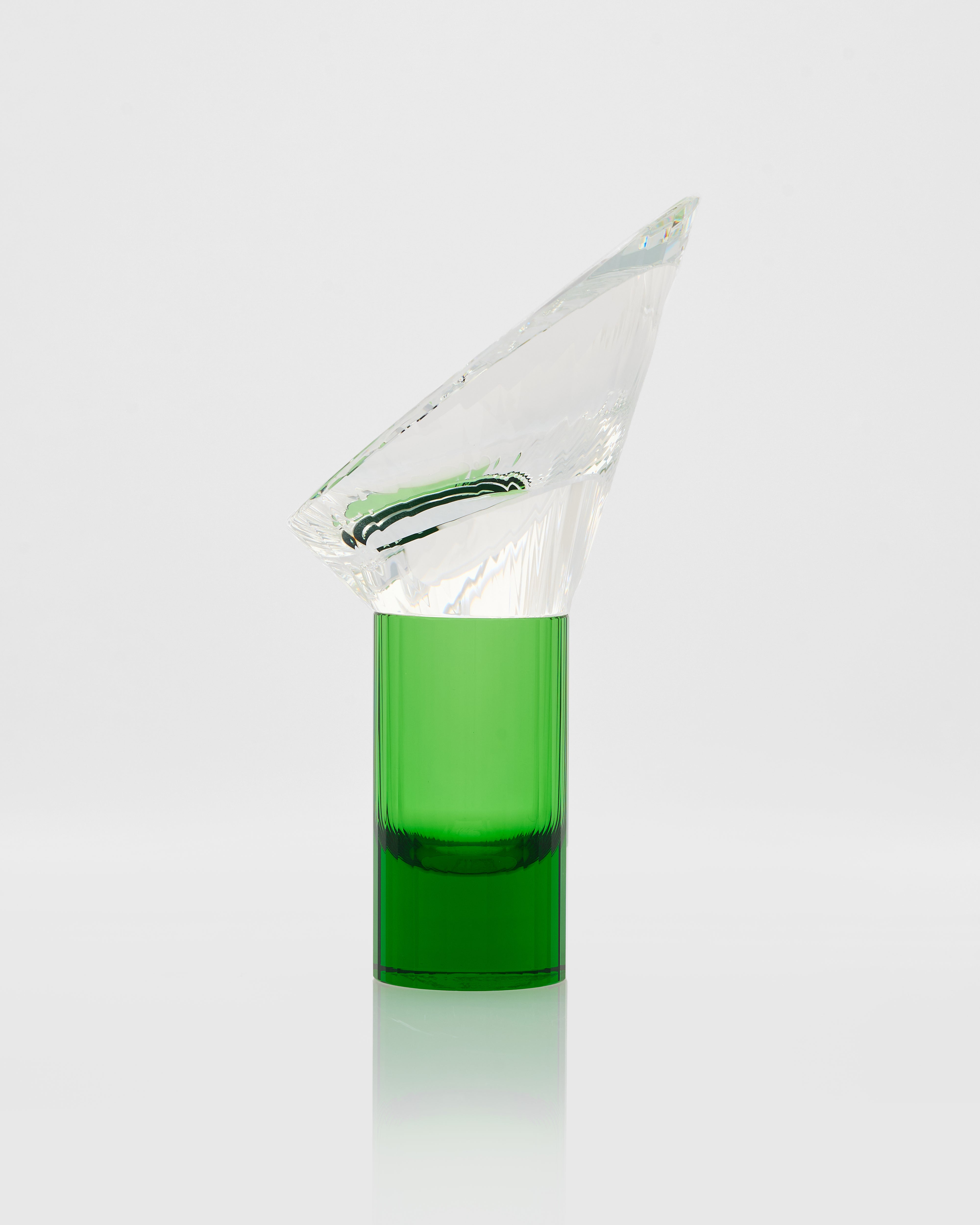 Clear glass container with green liquid on a white background
