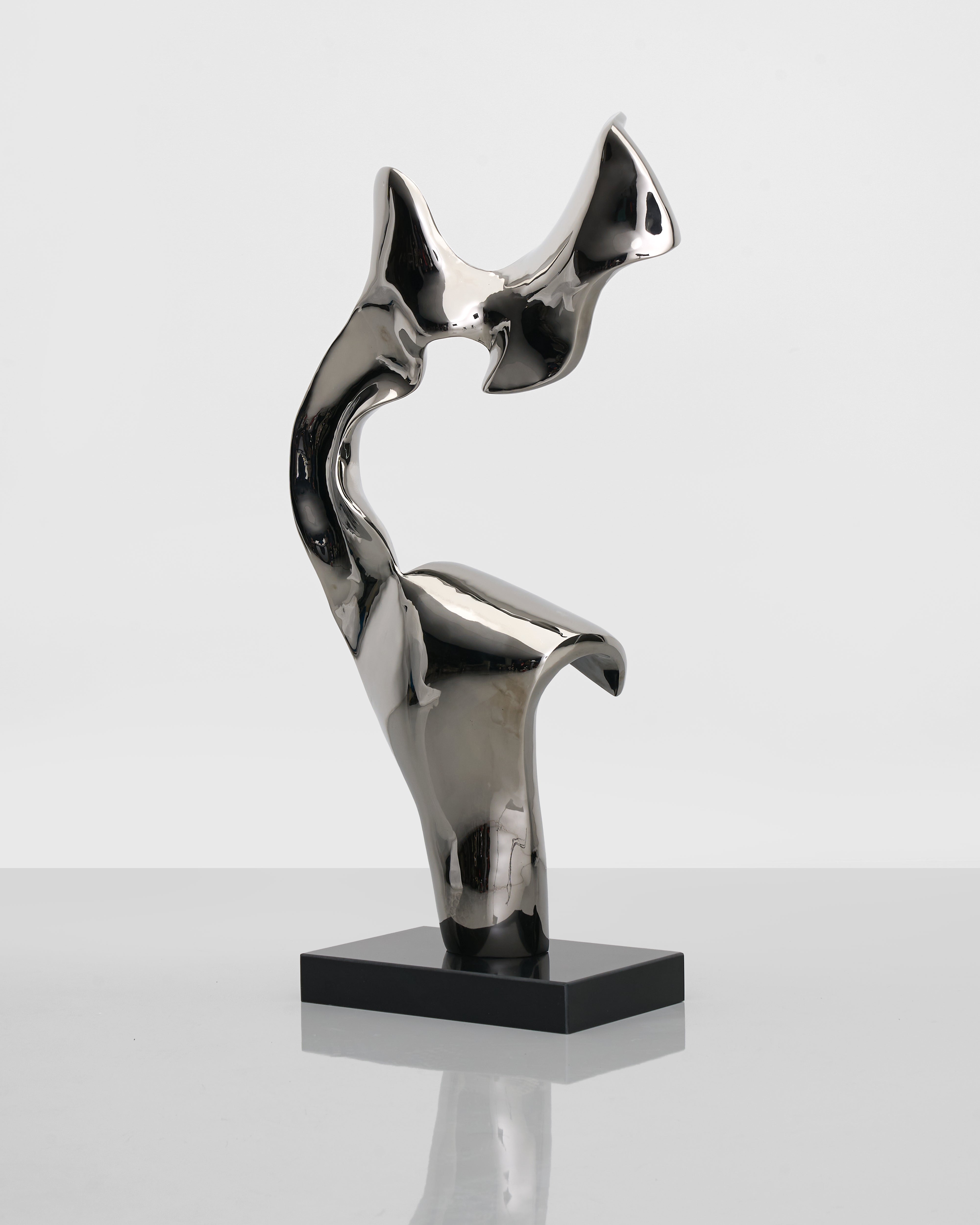 Eternal Silver Sculpture angled view showing sculptural curves and contemporary silver finish