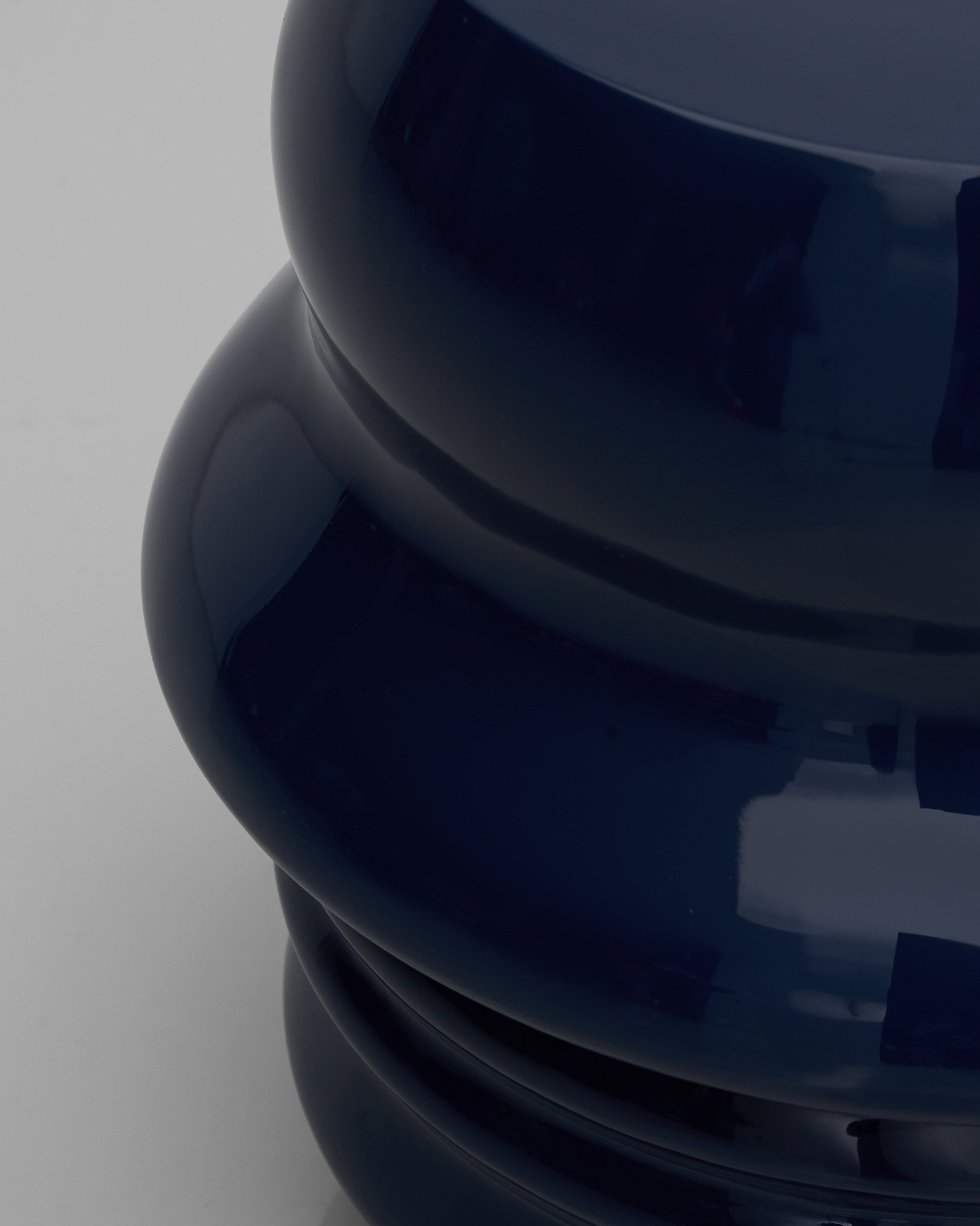 Detailed view of Felix duo face stool navy blue highlighting sculptural facial features and luxury finish