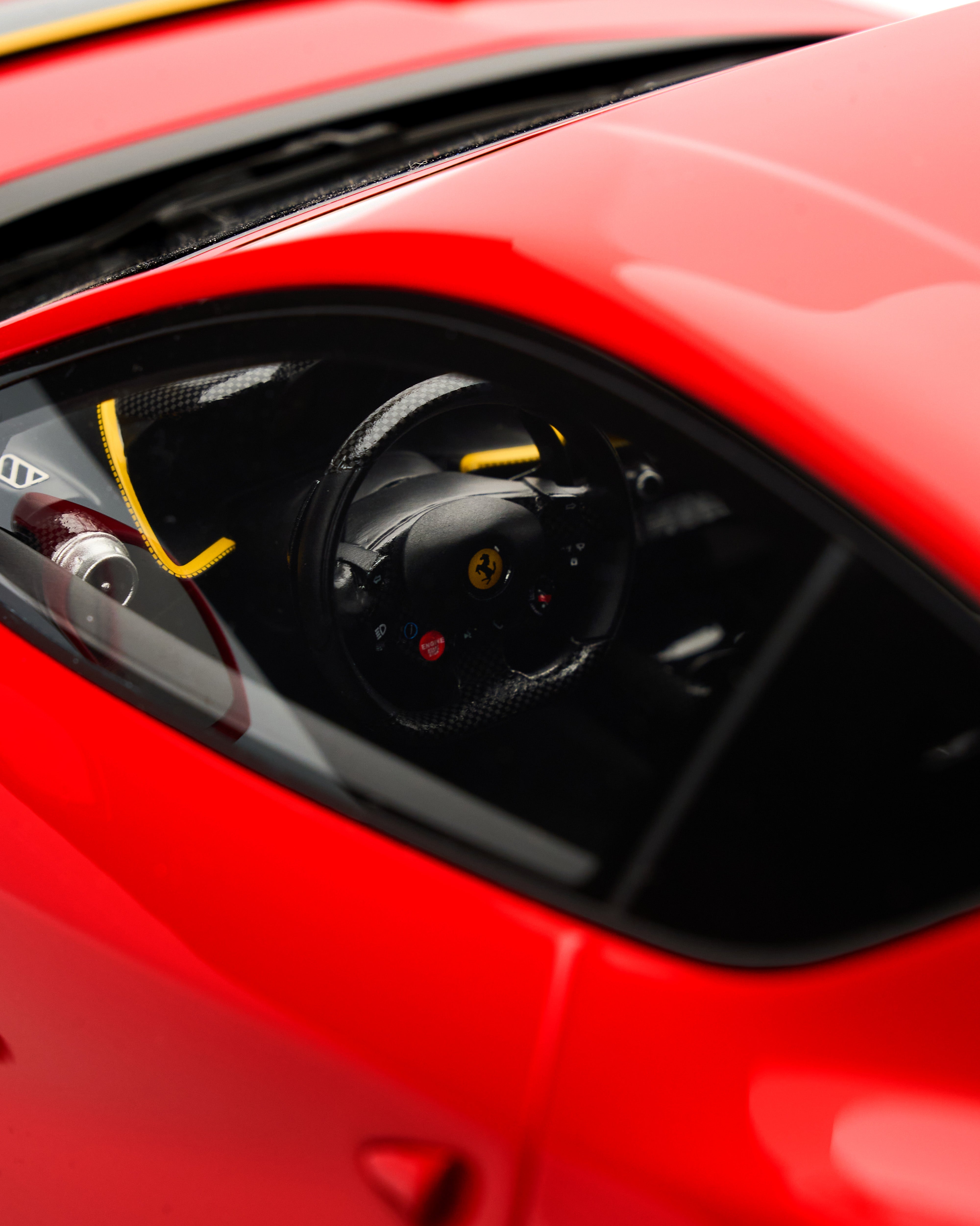 Close-up of a red car's headlight with visible branding ferrari 812