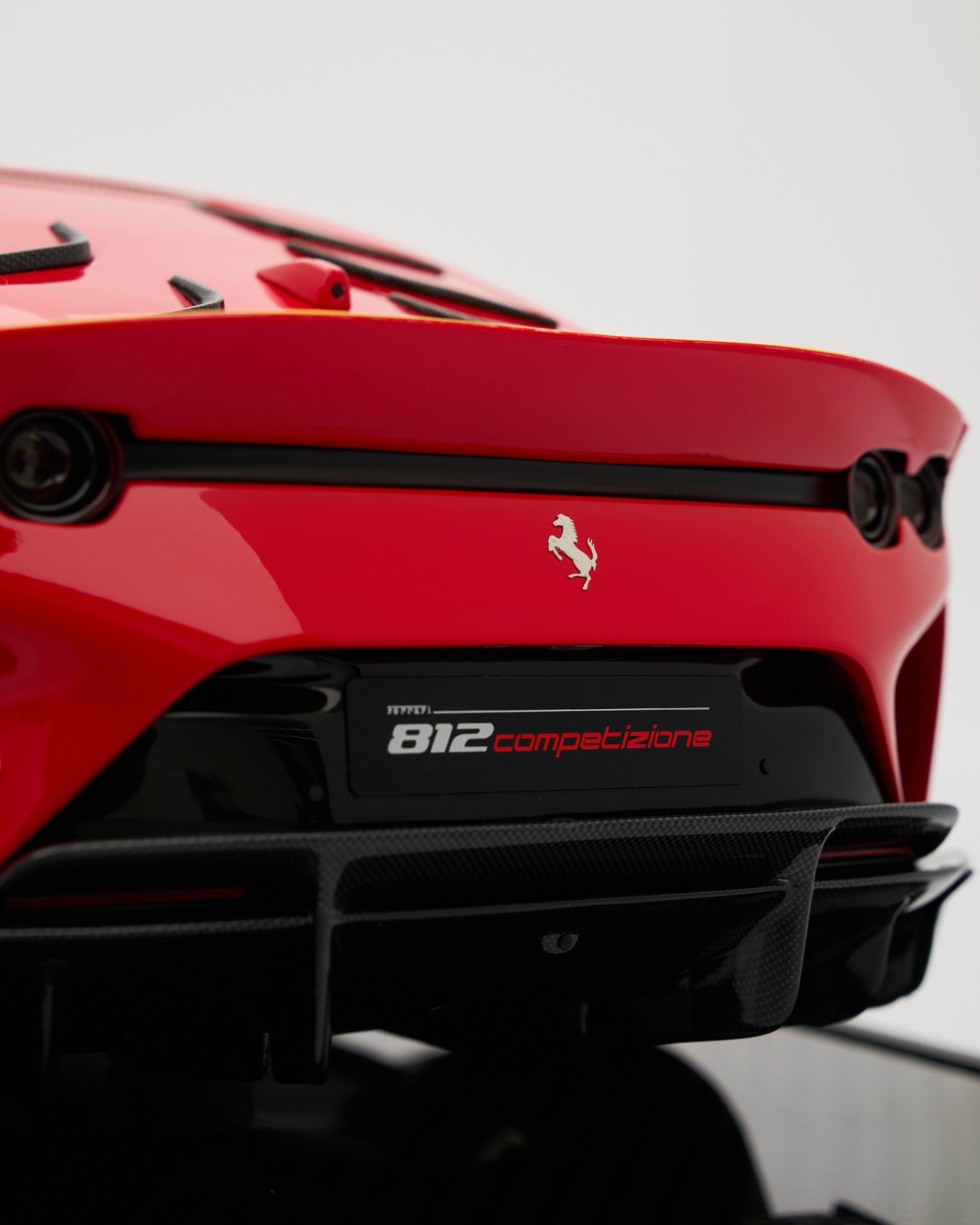 Red Ferrari 812 Competizione with visible logo on a white background