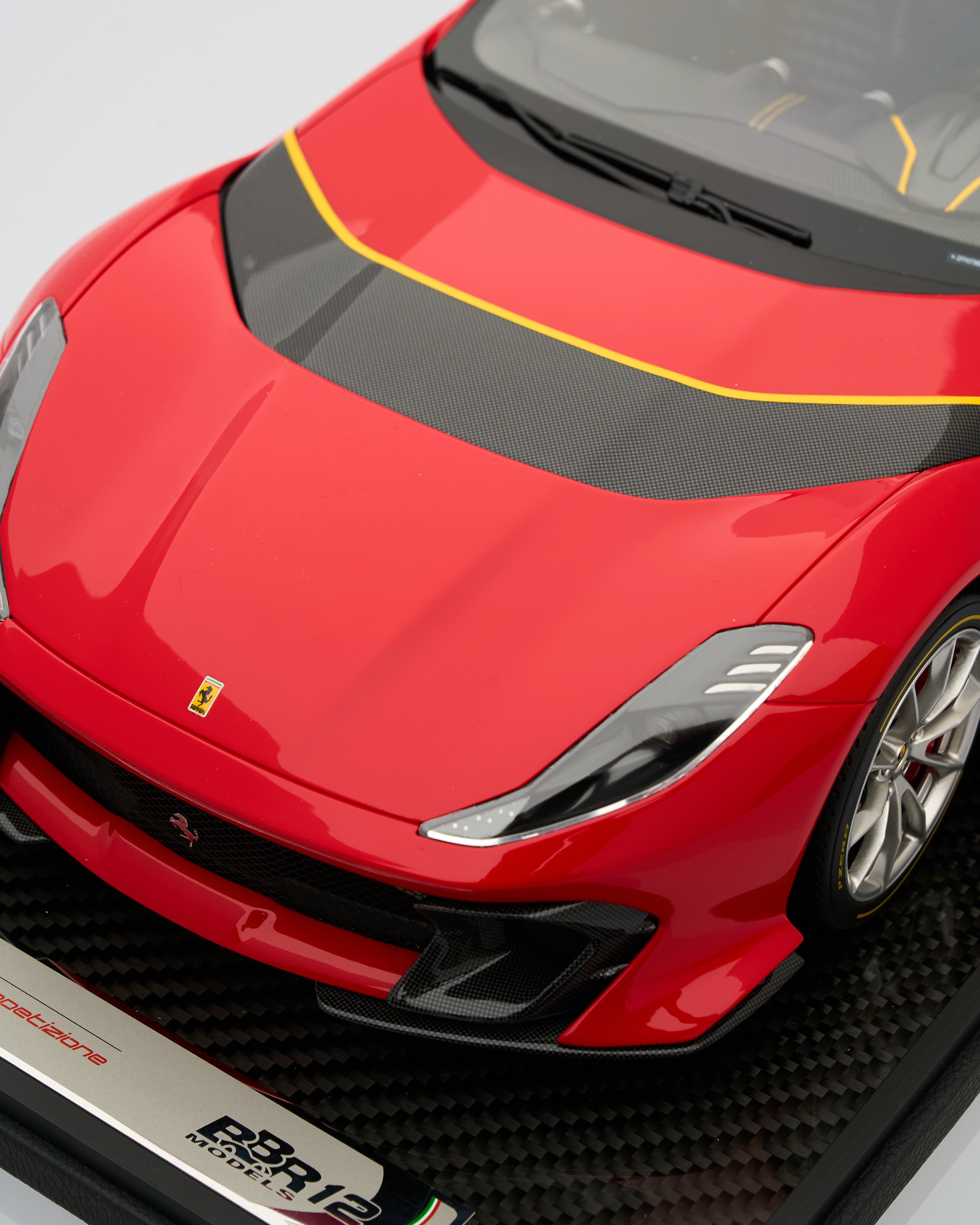 Close-up of a red sports car with visible branding on a gray background ferrari 812