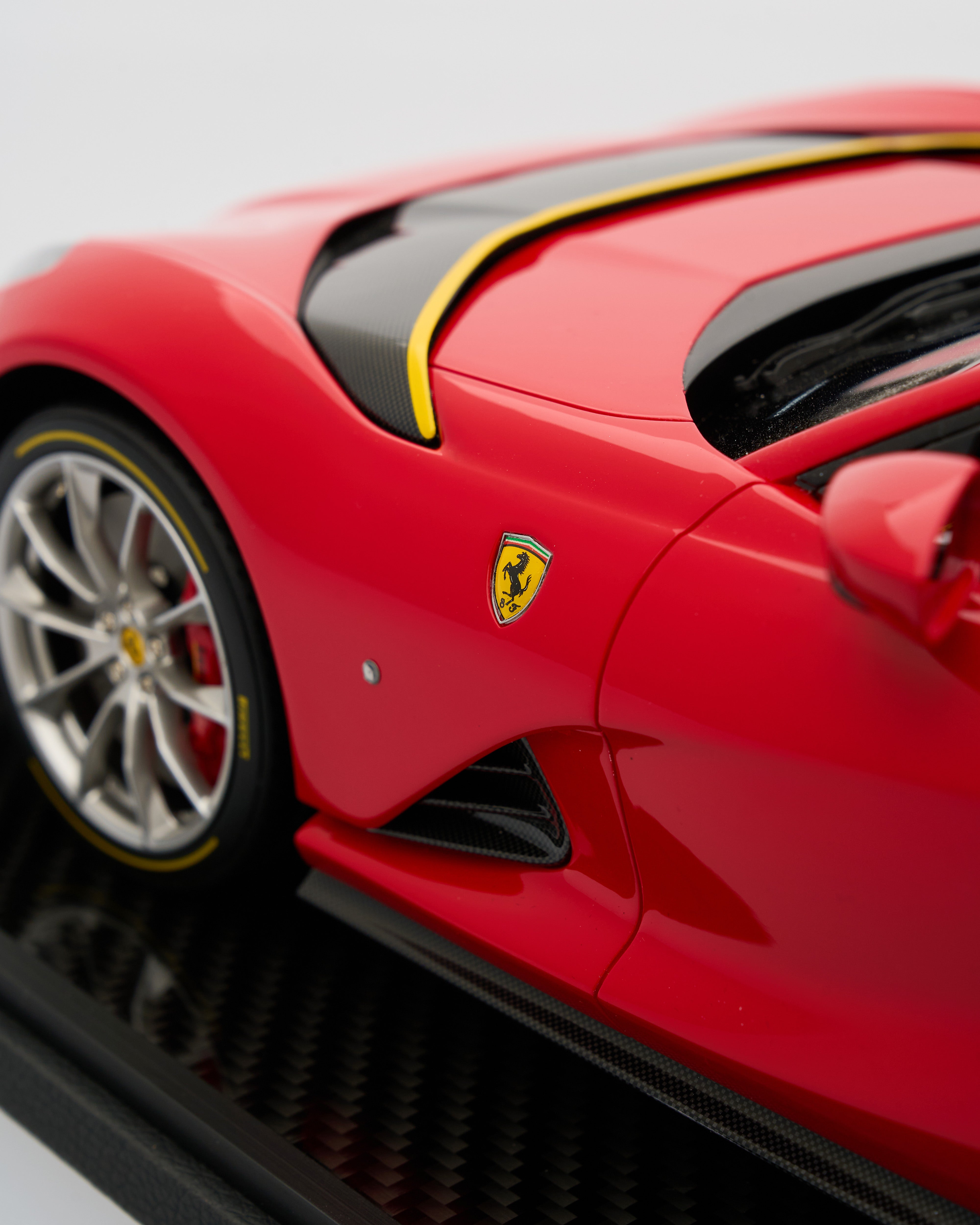 Close-up of a red Ferrari model car with the brand logo.