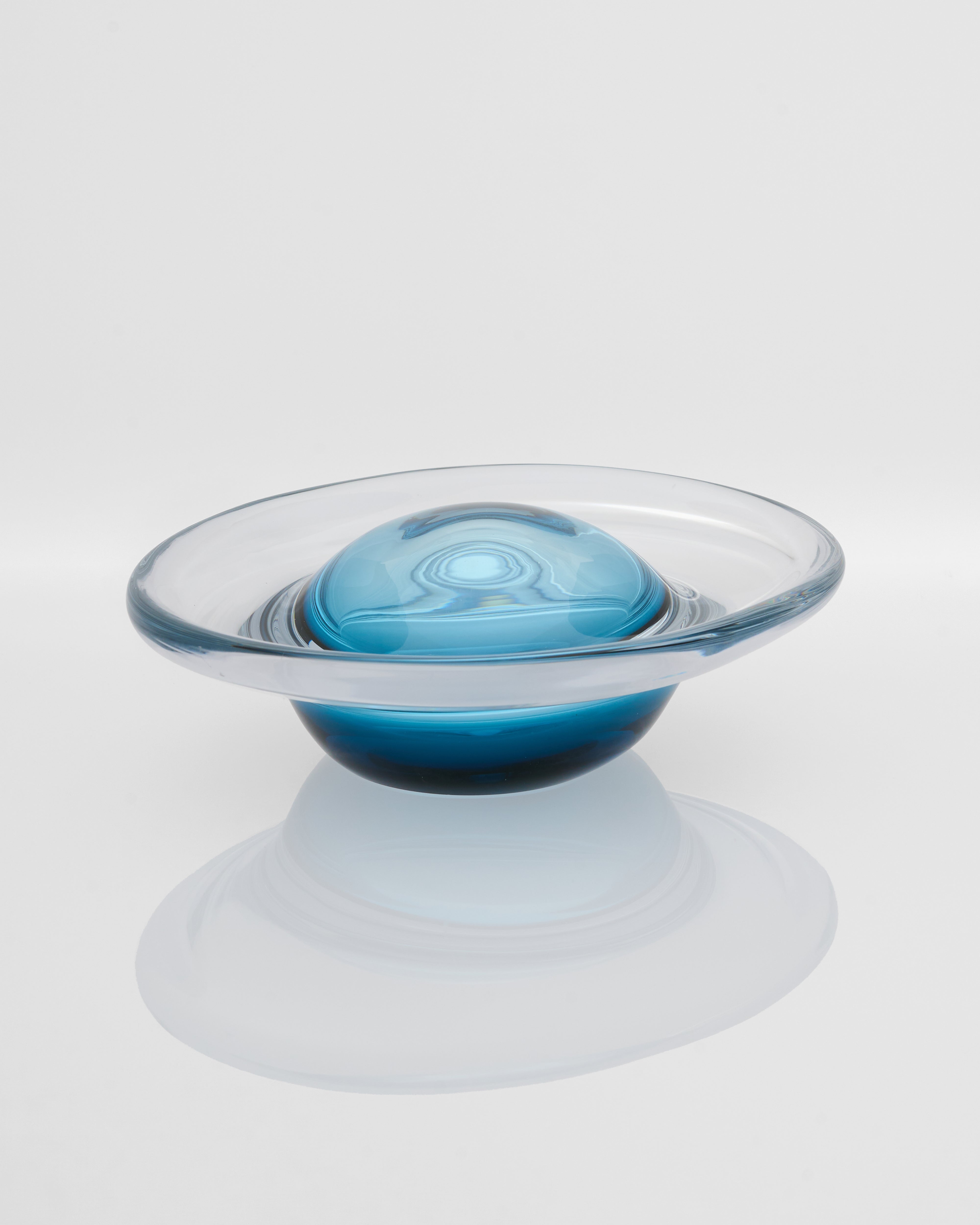 Clear glass bowl with a blue interior on a white background