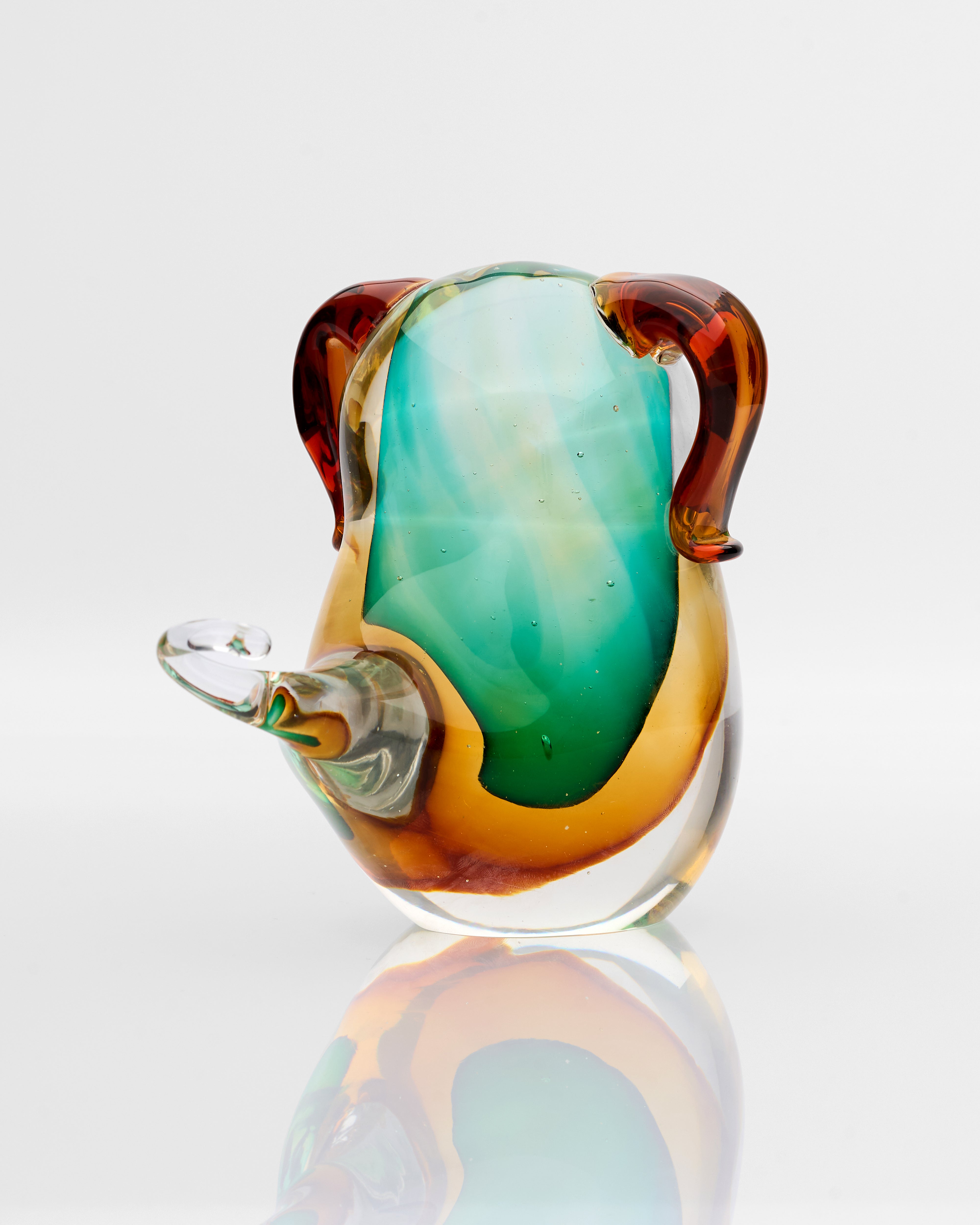Top view of glossy puppy glass decor displaying reflective surface and refined sculptural shape