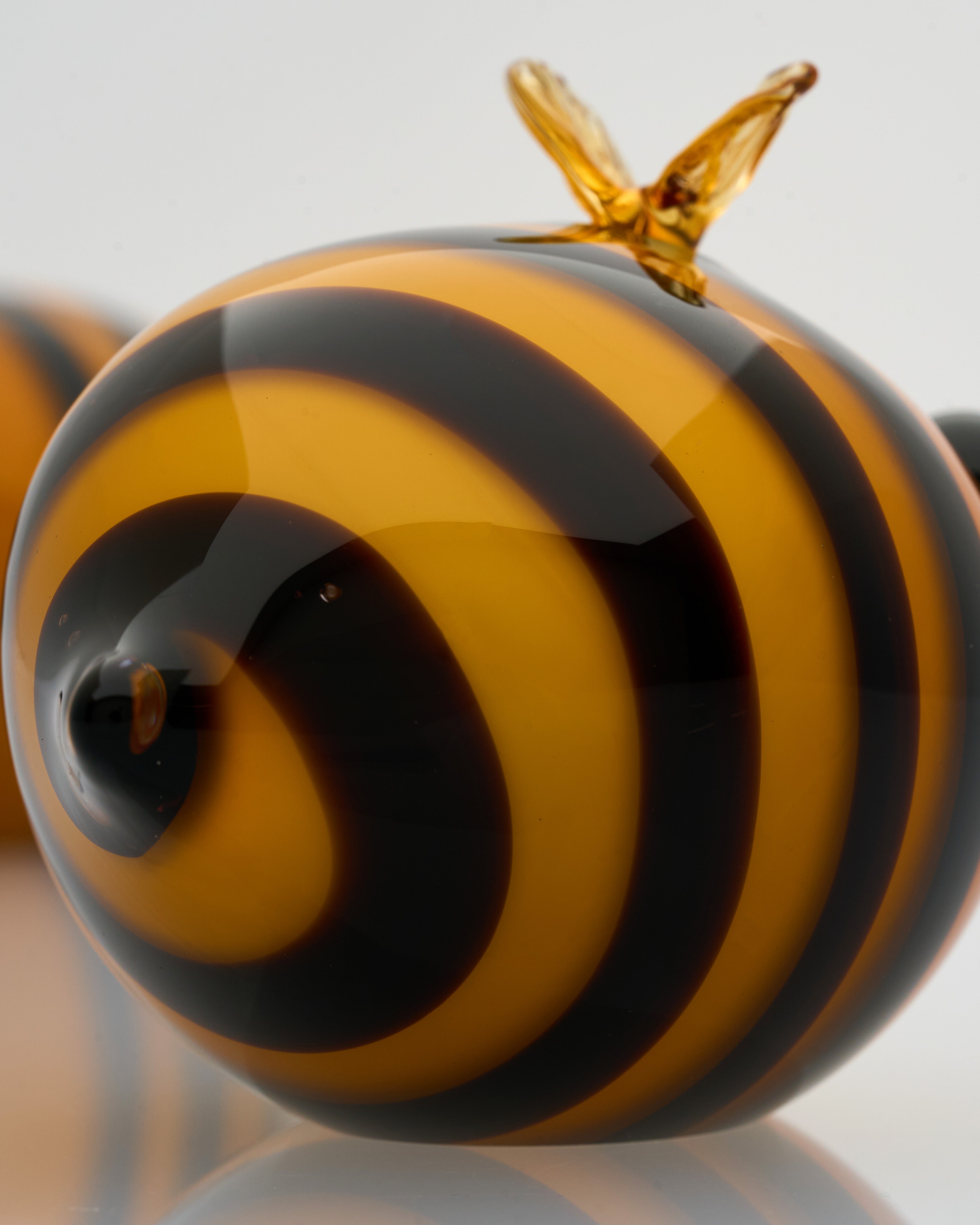 Close-up of Honey Bee perfume bottle decor highlighting refined glasswork and artistic bee detailing