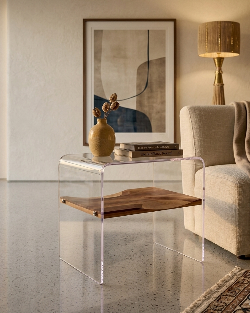 Modern living room with a clear side table, beige sofa, and abstract art.