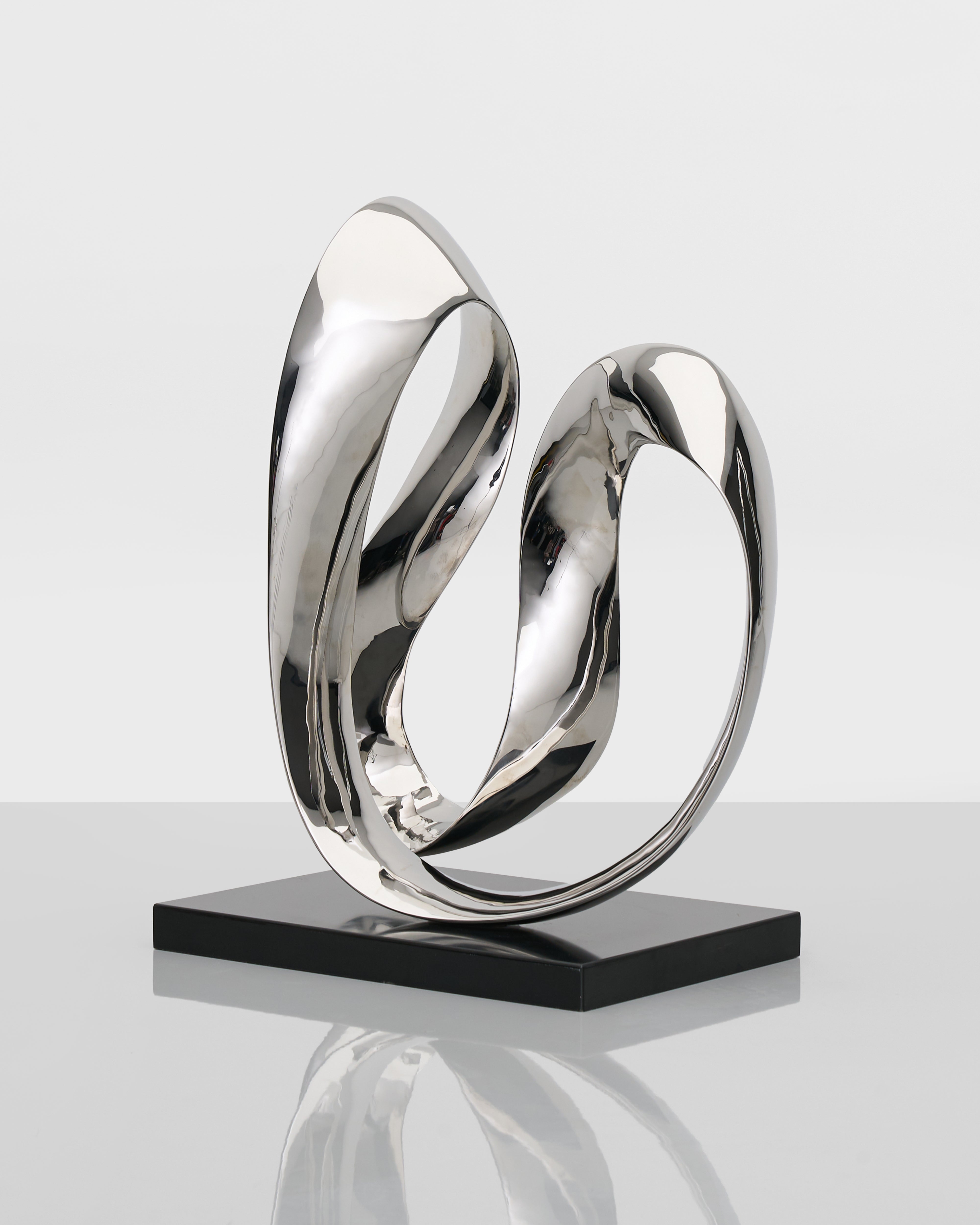Side view of Infinite Large Sculpture highlighting sculptural form and refined silver finish