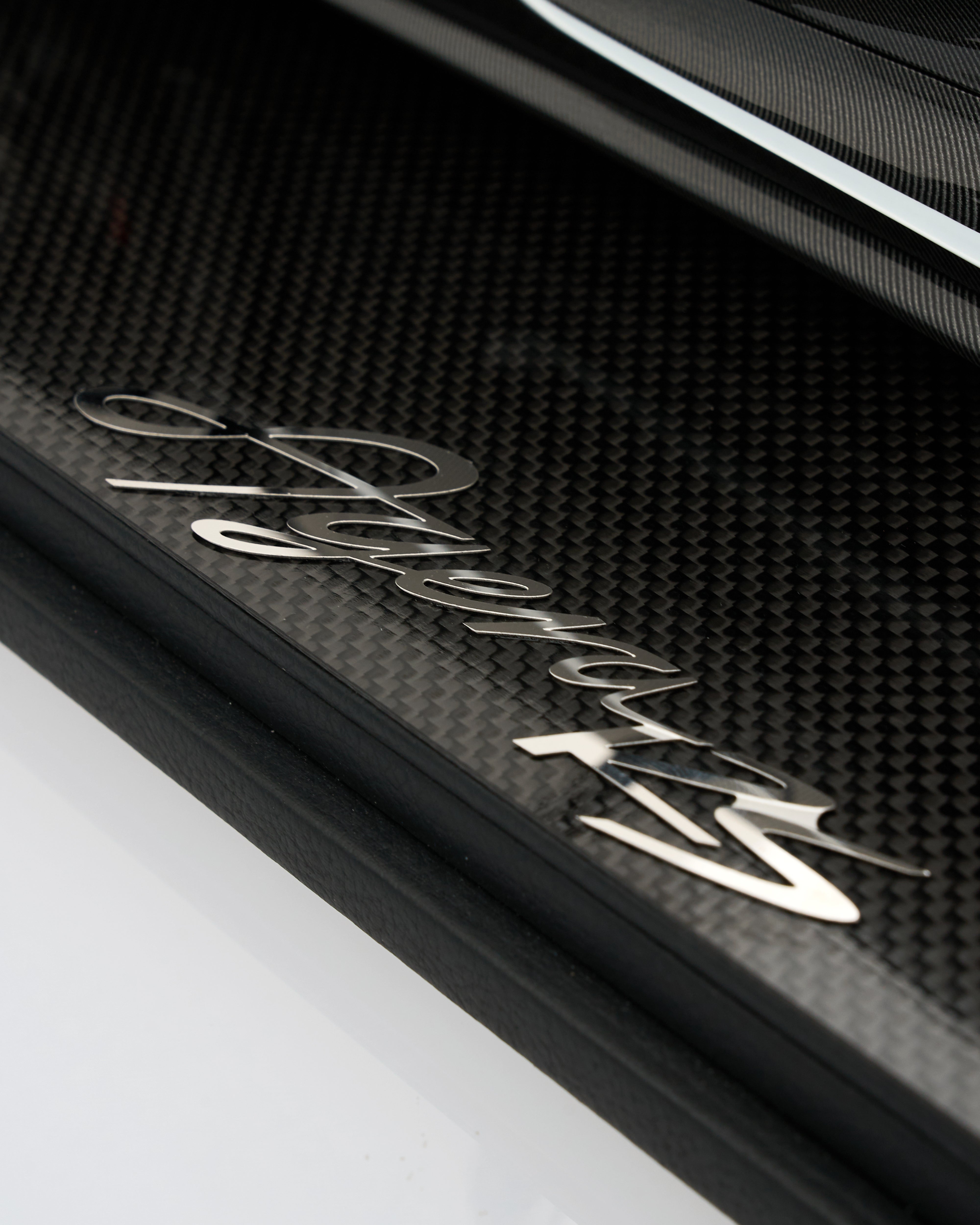 Close-up of a carbon fiber surface with 'Agera RS' branding.