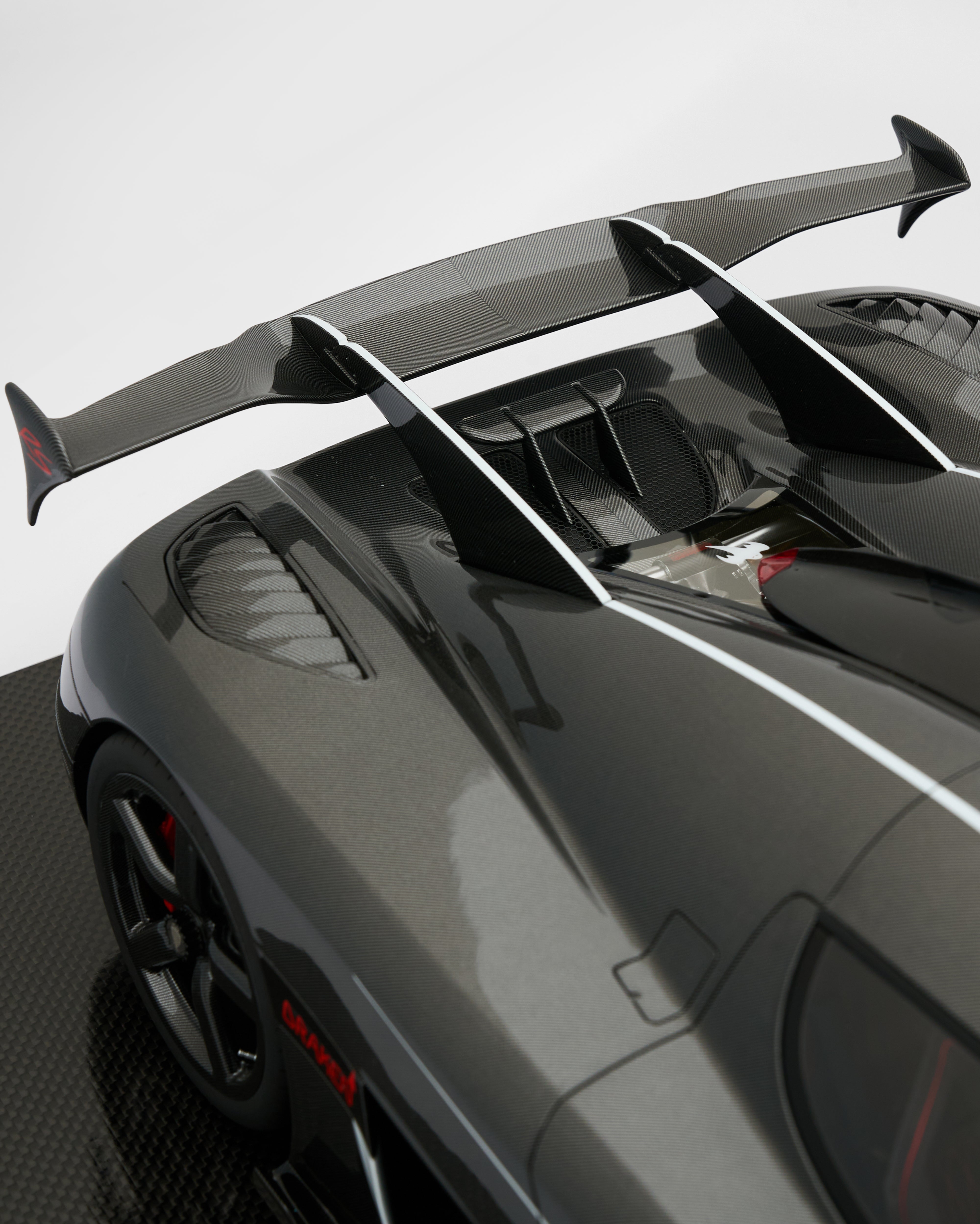 Close-up of a car's rear wing on a gray background