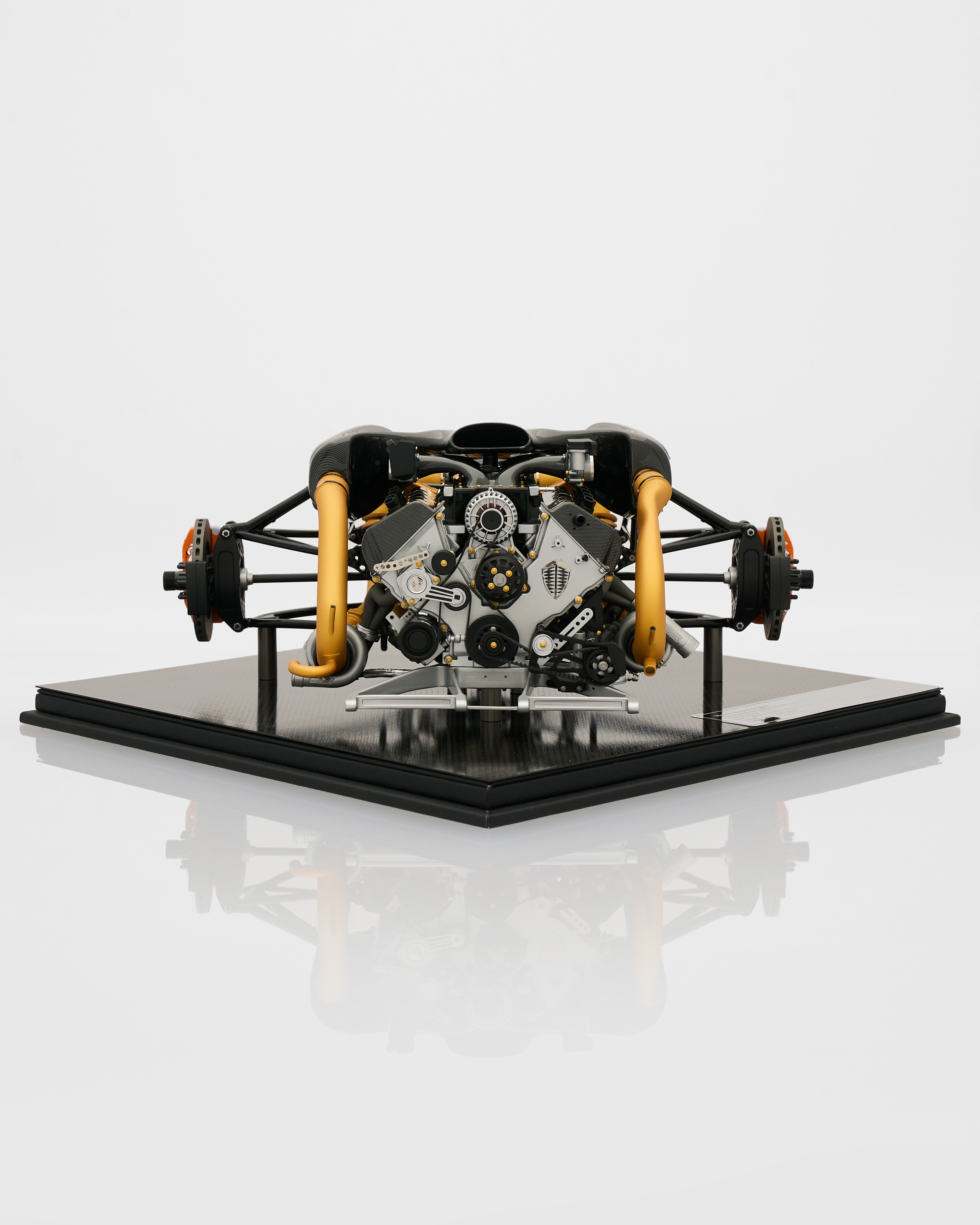 Engine model on a reflective surface with a white background